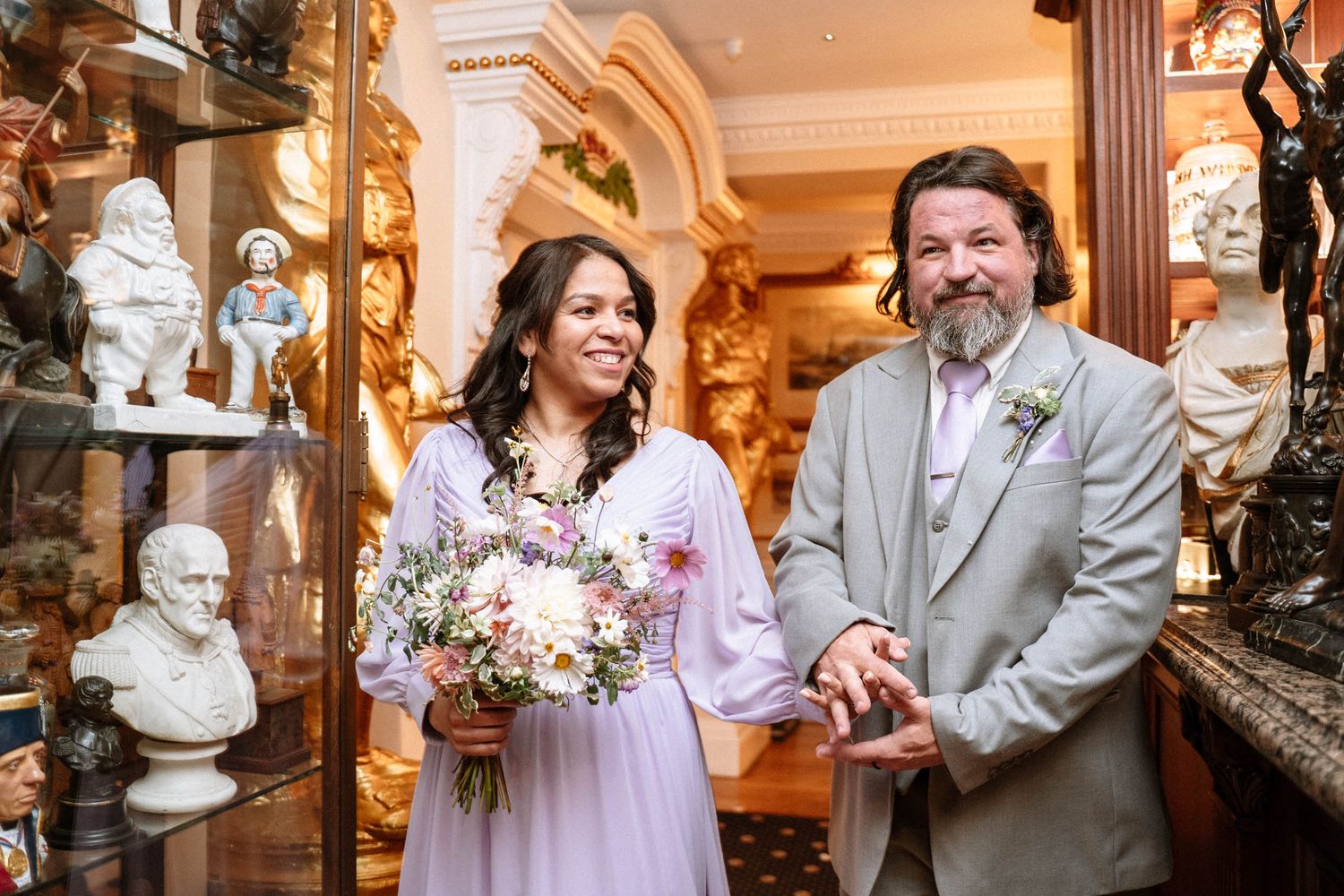 Bride walking with groom inside Trafalgar Tavern wedding reception