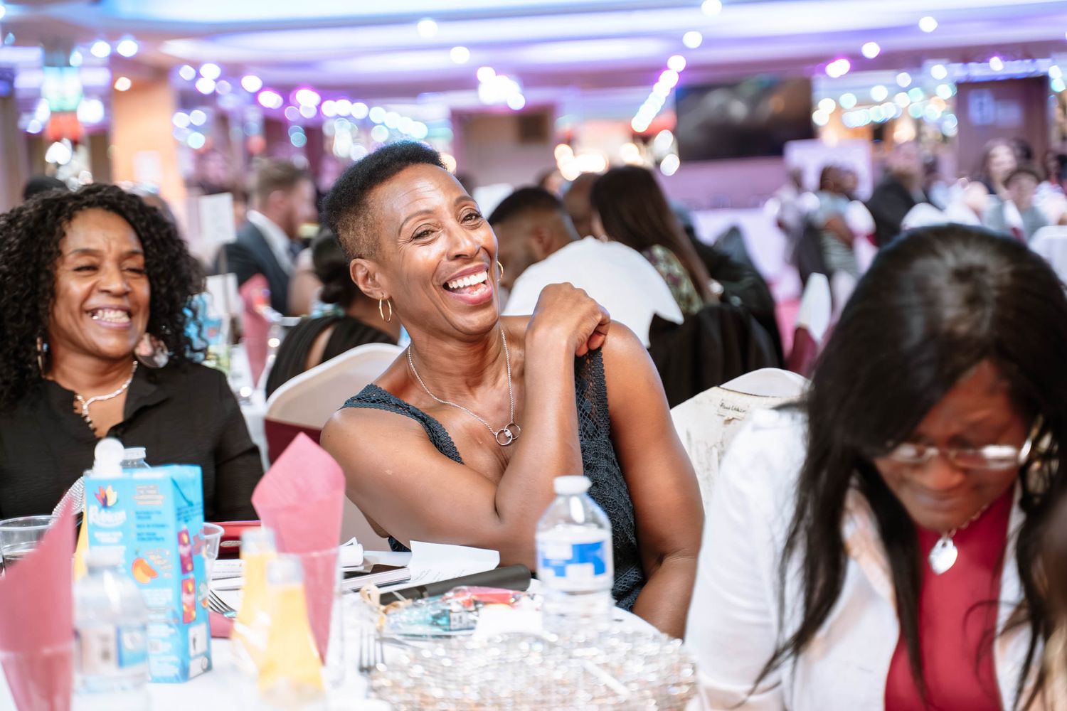 Guests laughing during Jamaican wedding reception in Birmingham