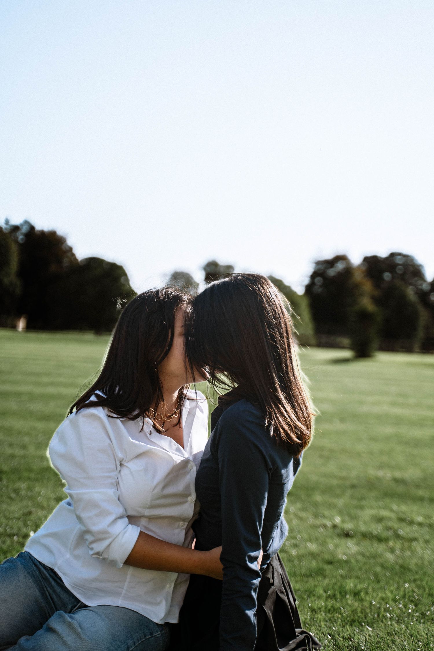 Carolina and Mia kissing outdoors during their lesbian proposal photography session near Cardiff