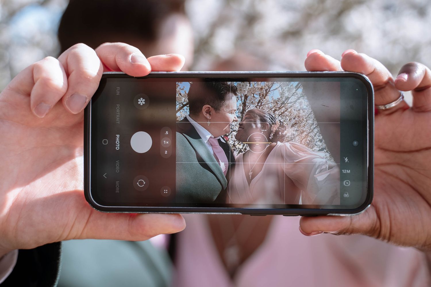 Phone capturing couple during Manchester wedding ceremony