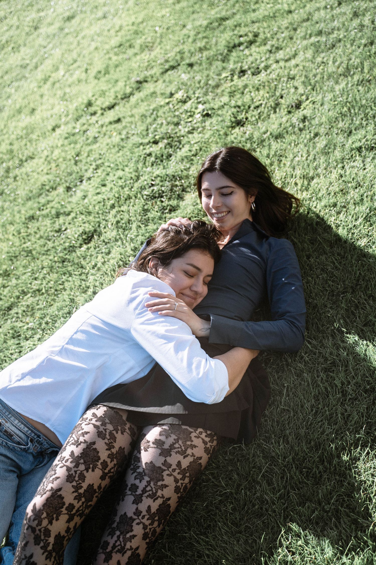 Couple lying on grass during Cardiff proposal photography session