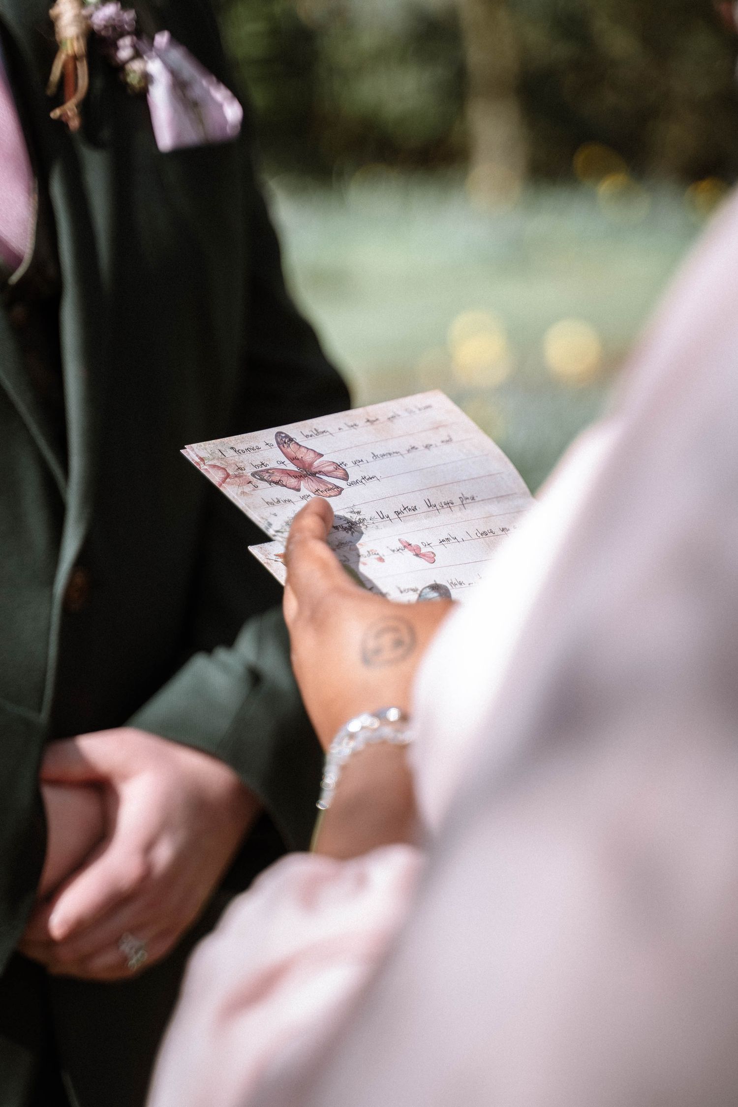 Hands holding wedding paperwork during Manchester registry office ceremony