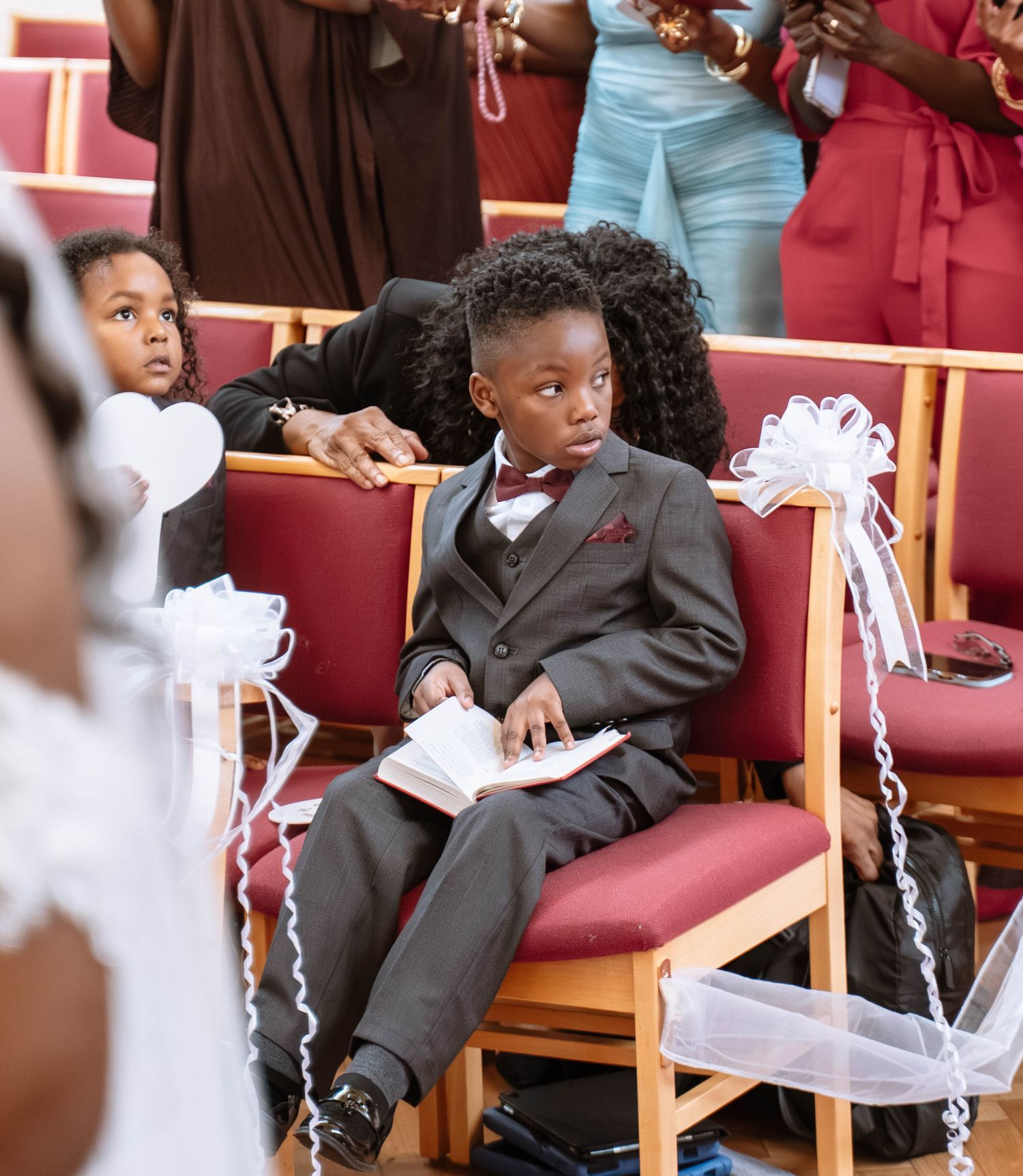 Child sitting during Jamaican church wedding ceremony in Birmingham