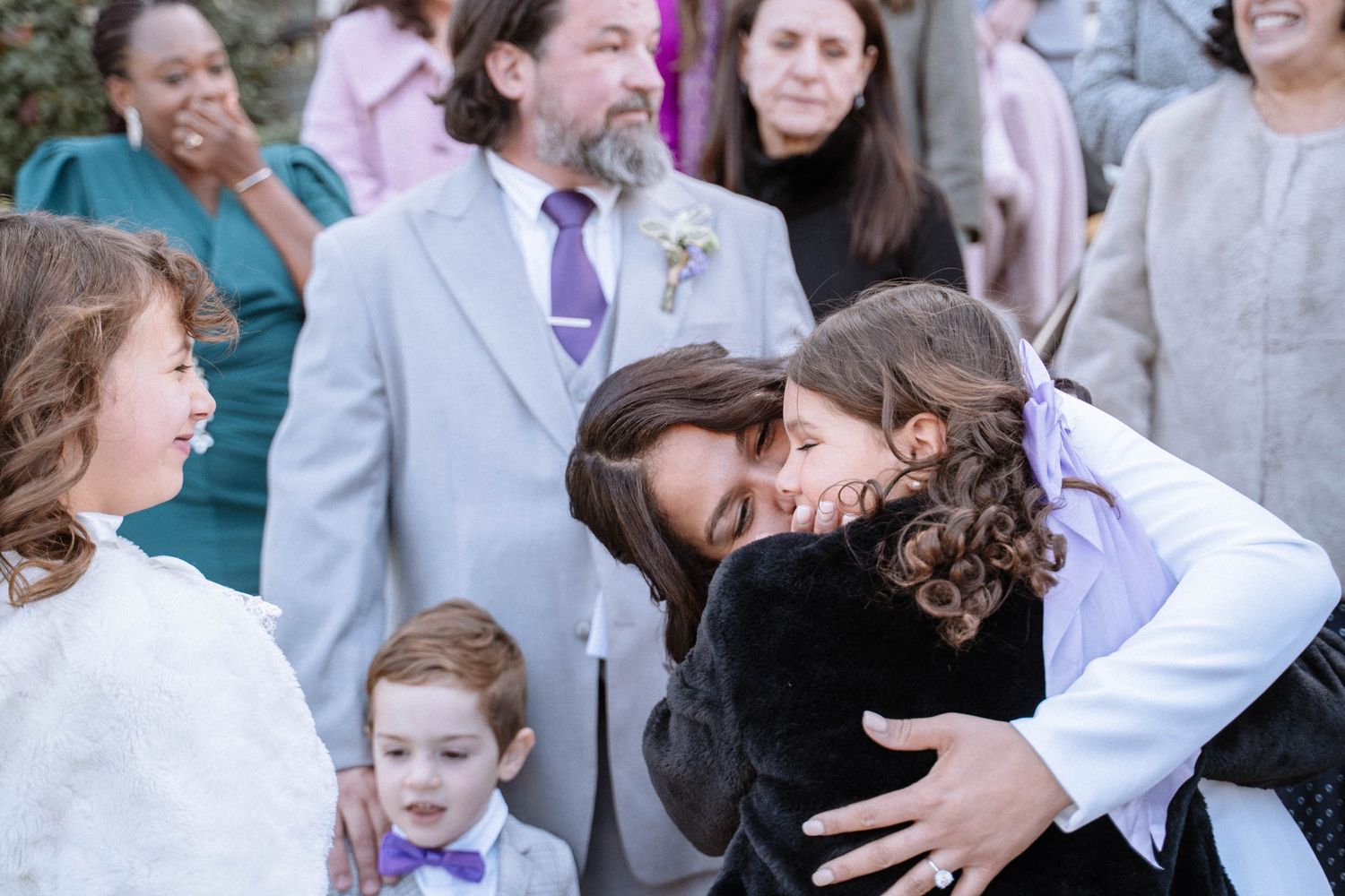 Family hugging during wedding celebration outside LDS ceremony venue
