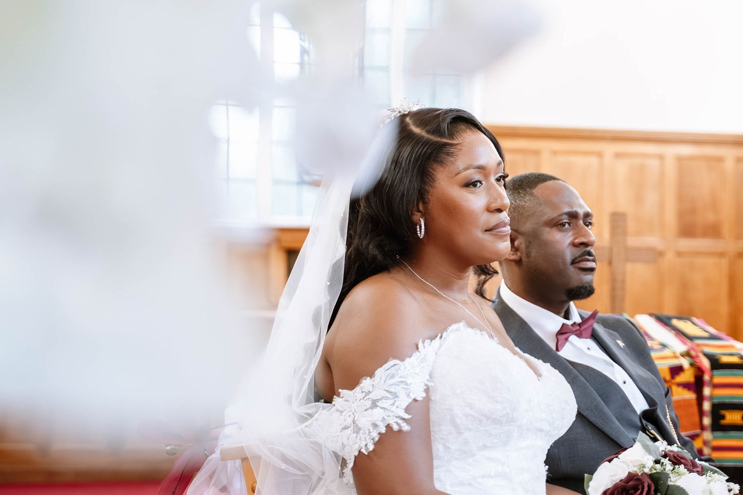 Birmingham Jamaican church wedding ceremony bride and groom seated during vows emotional candid moment indoors