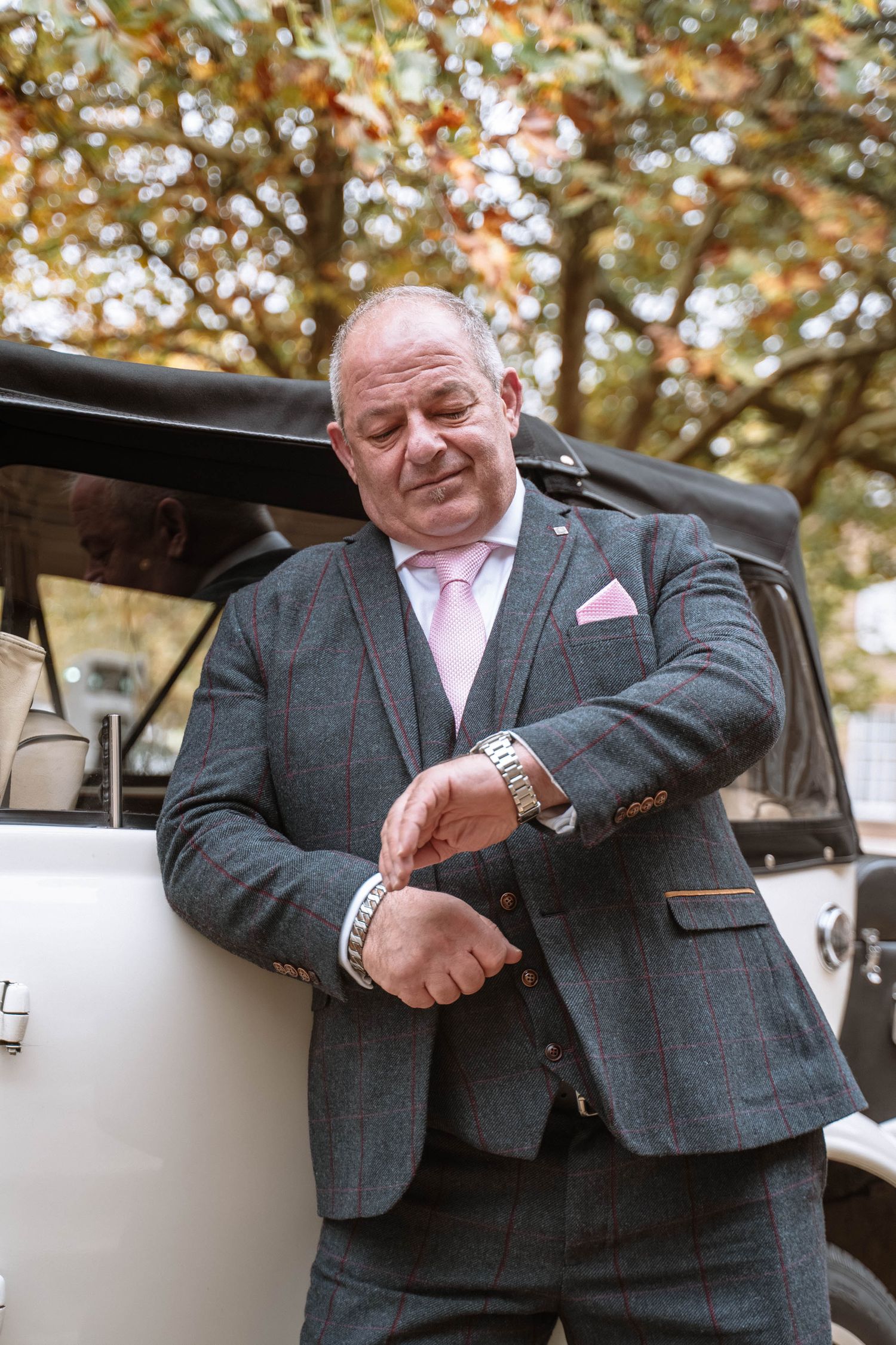 Candid wedding photography of a groom outside