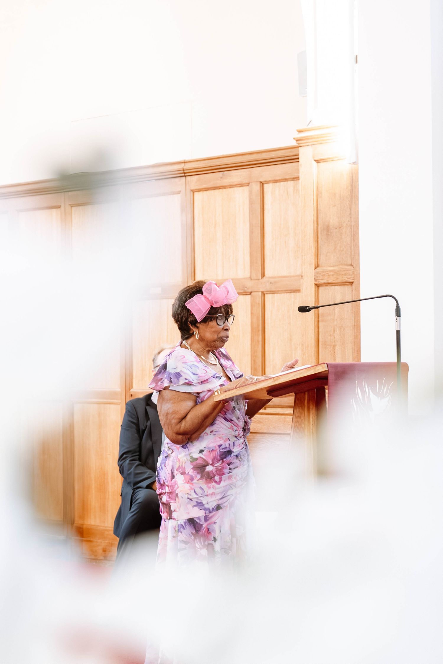Speaker at podium during Jamaican church wedding ceremony in Birmingham