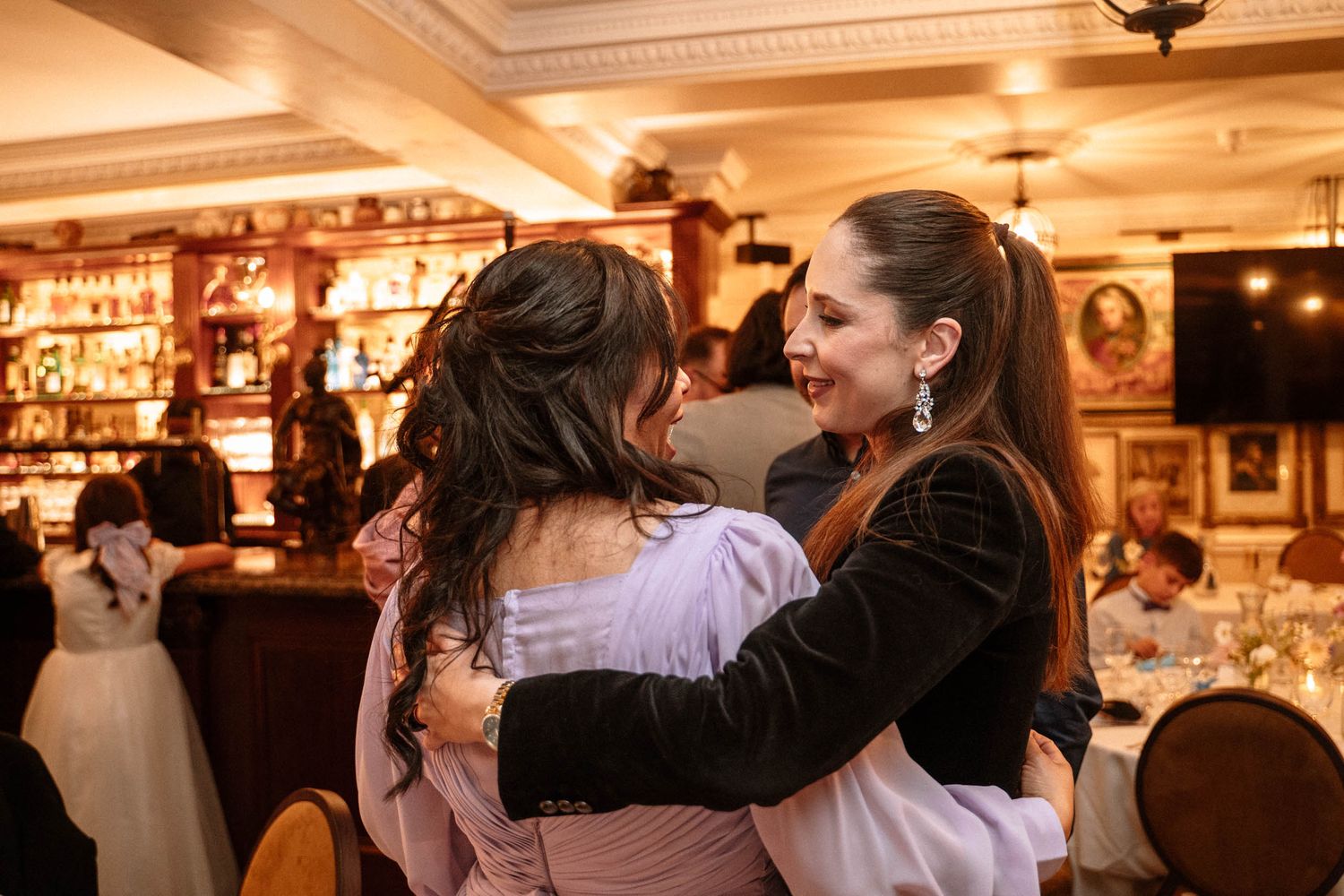 Guests hugging during wedding reception at Trafalgar Tavern London