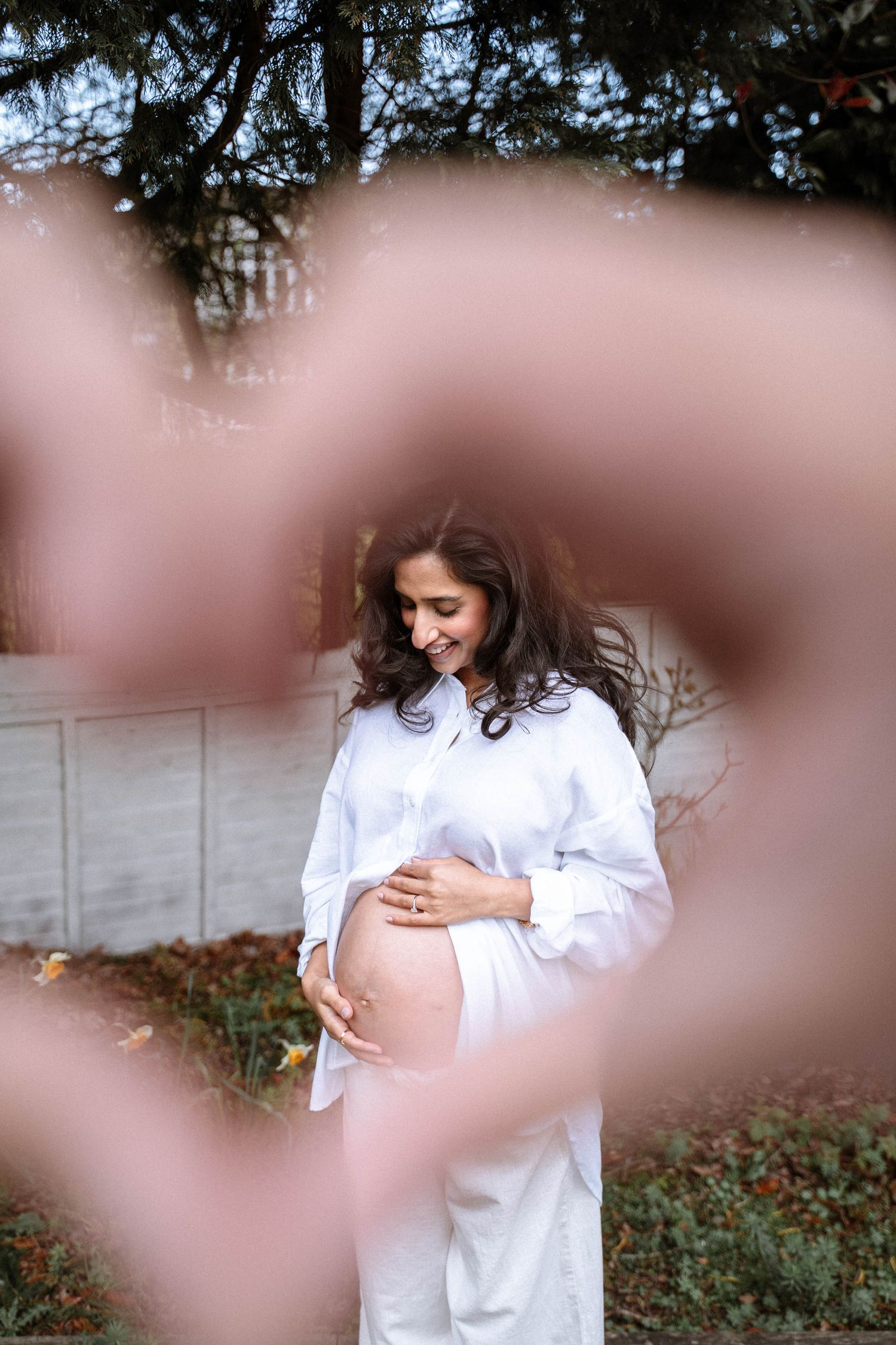 South asian couple doing photography pose during maternity photoshoot