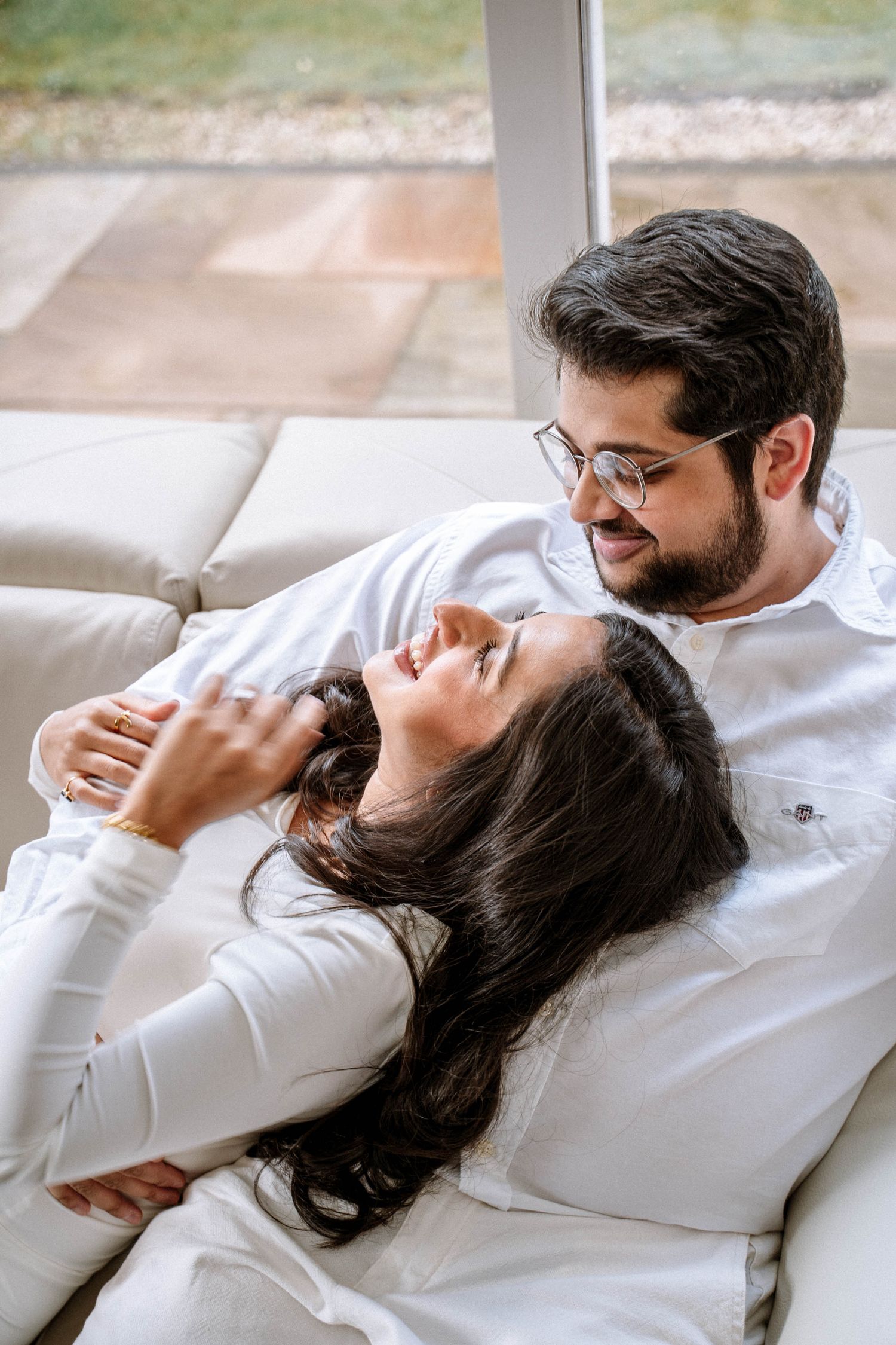 South asian couple looking at each other smiling during maternity photography