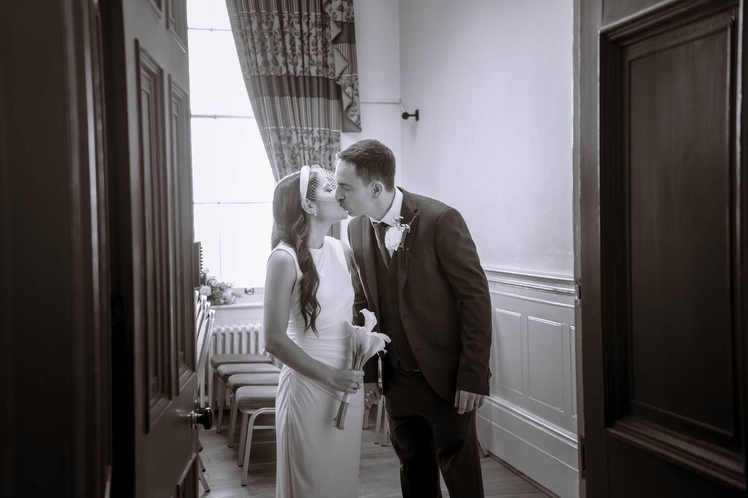 Couple sharing a quiet moment inside Liverpool St George Hall after their civil ceremony