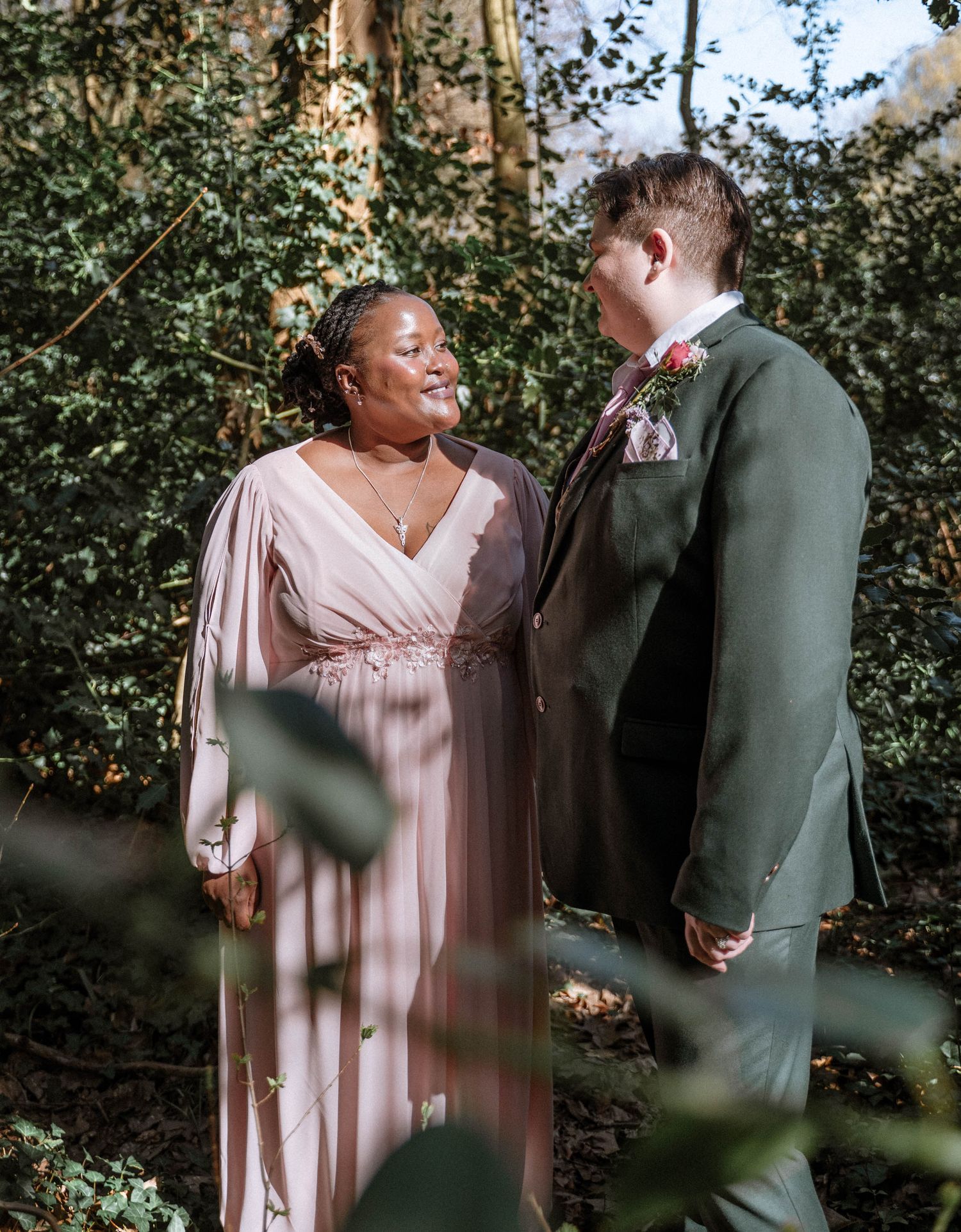 Couple standing together in greenery during Manchester LGBTQ wedding