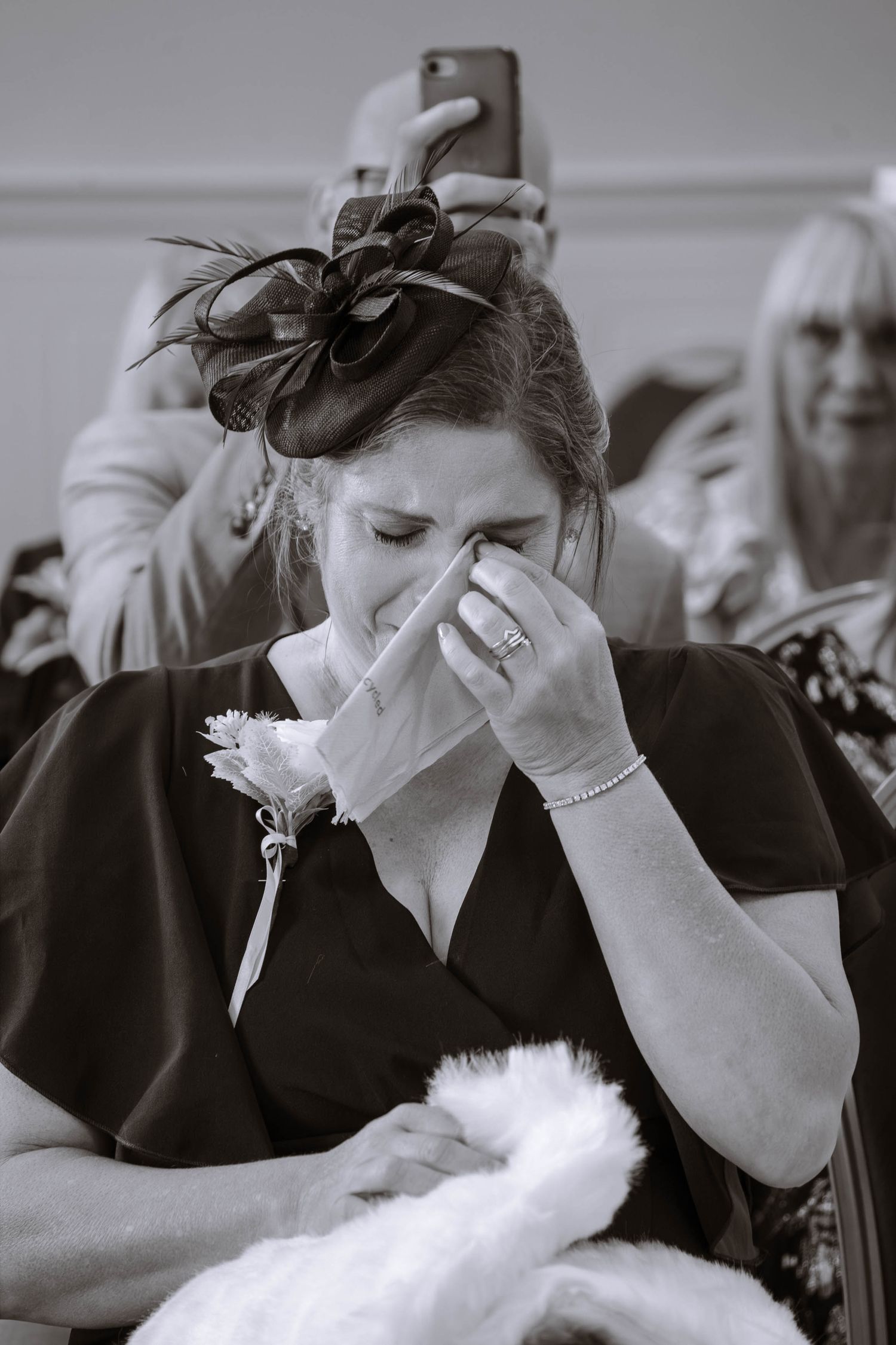 Guest crying and seated during a small civil wedding at Liverpool St George Hall