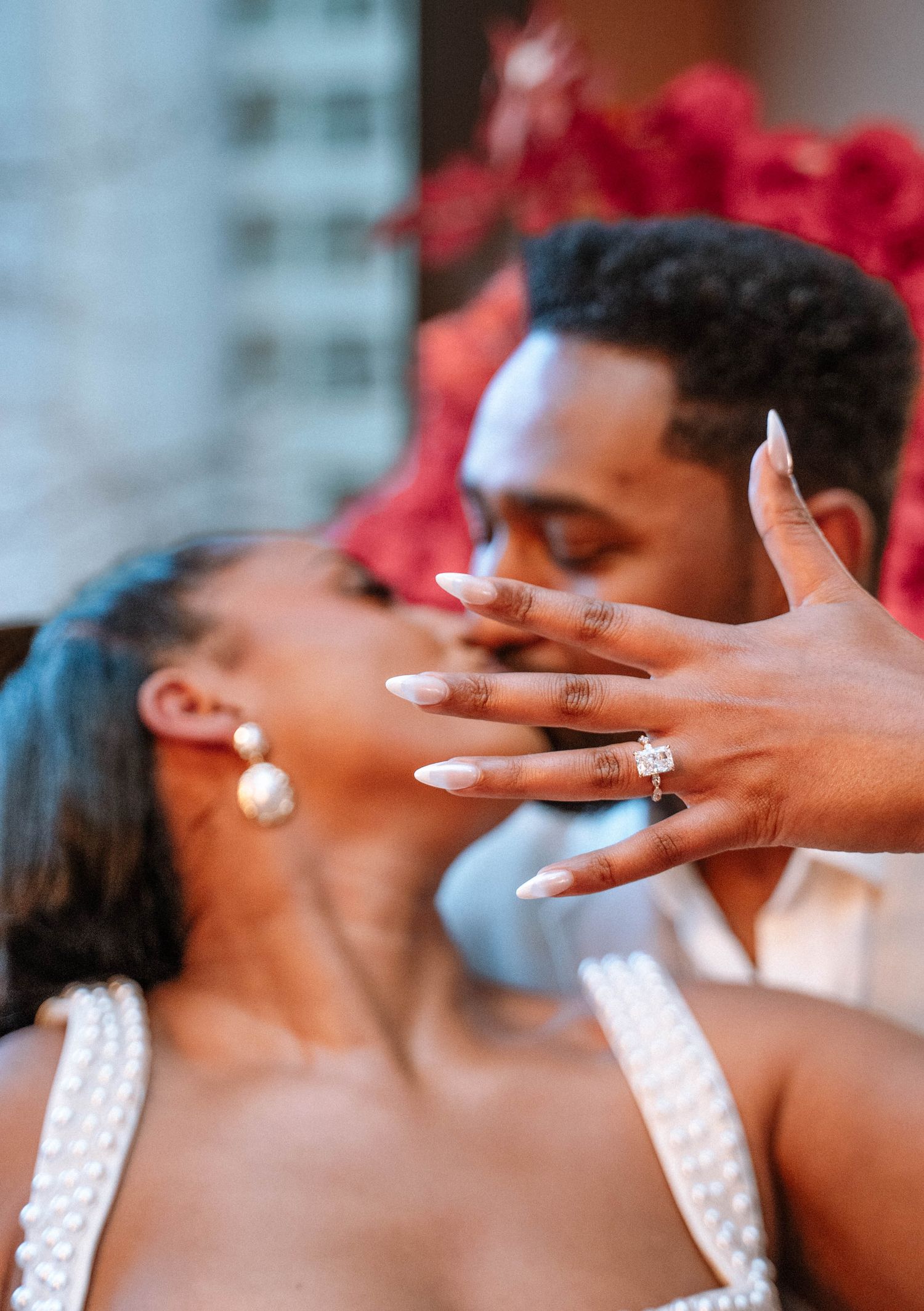 Couple celebrating after a surprise proposal in Manchester city centre