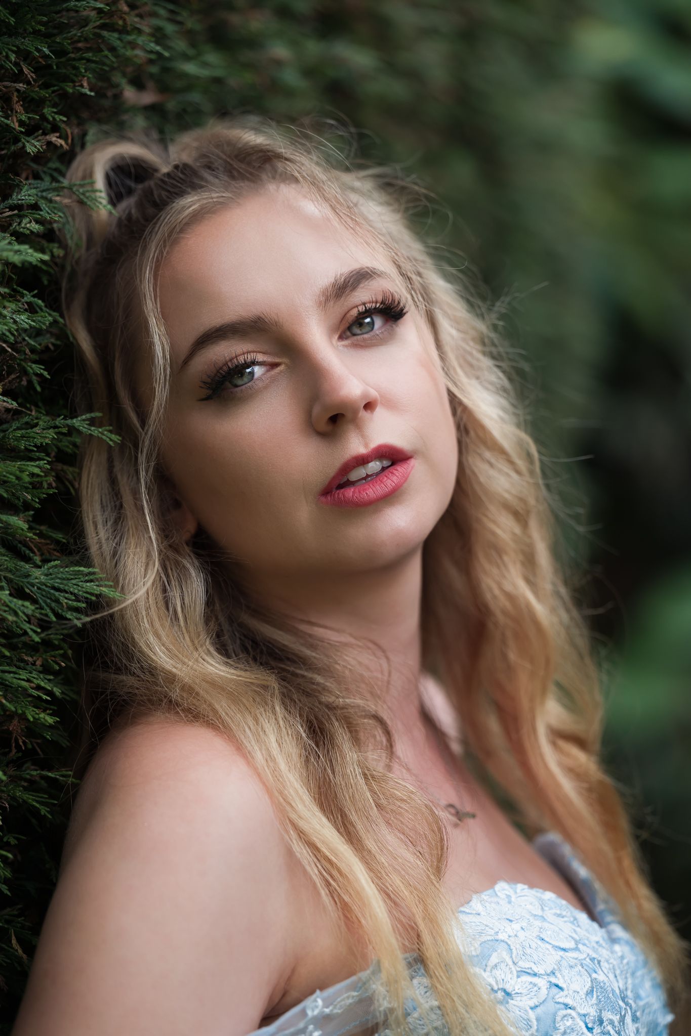 Romantic portrait in natural setting wearing delicate lace dress.