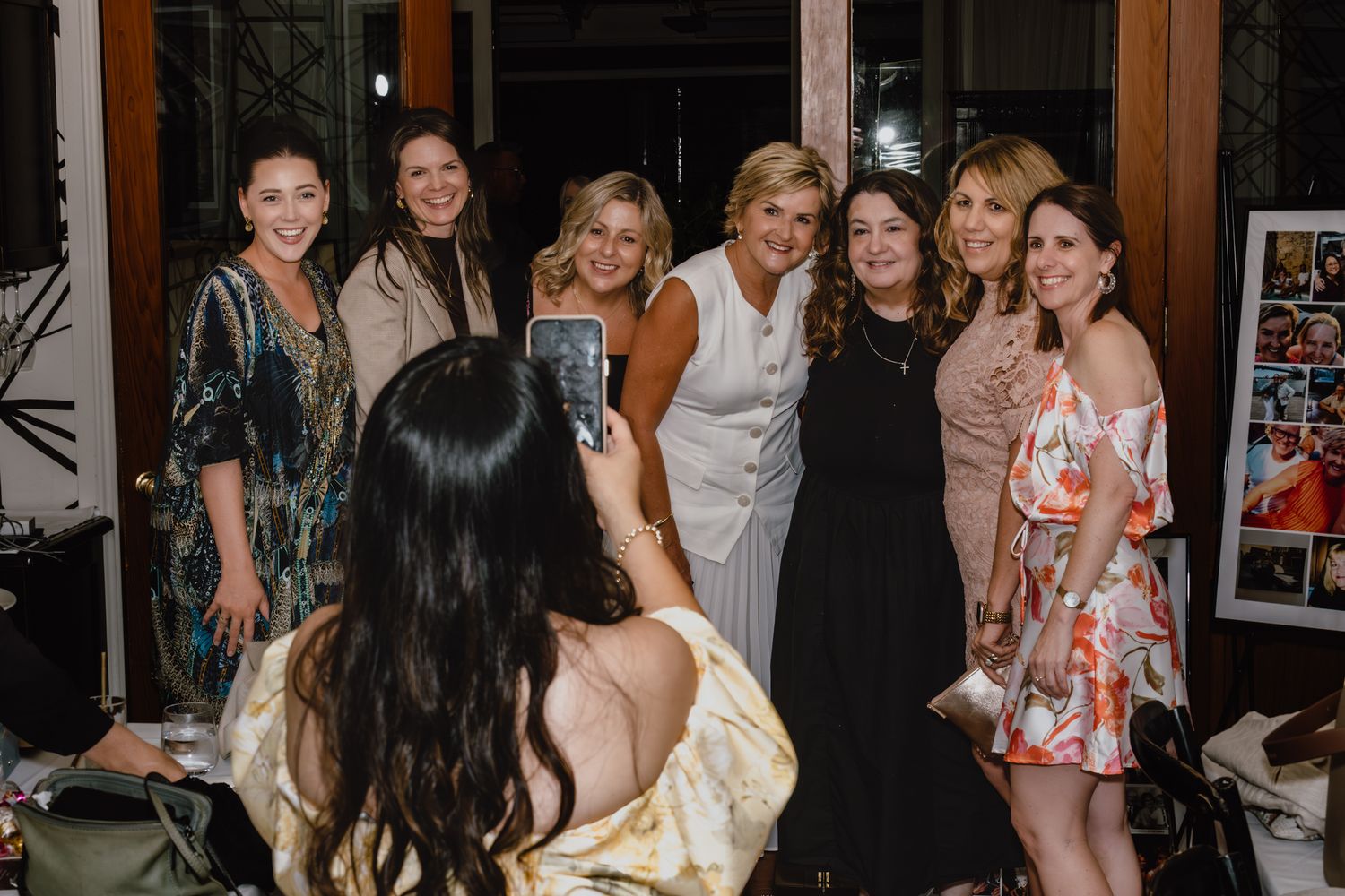 Group of party guests gathered together at an evening celebration event.