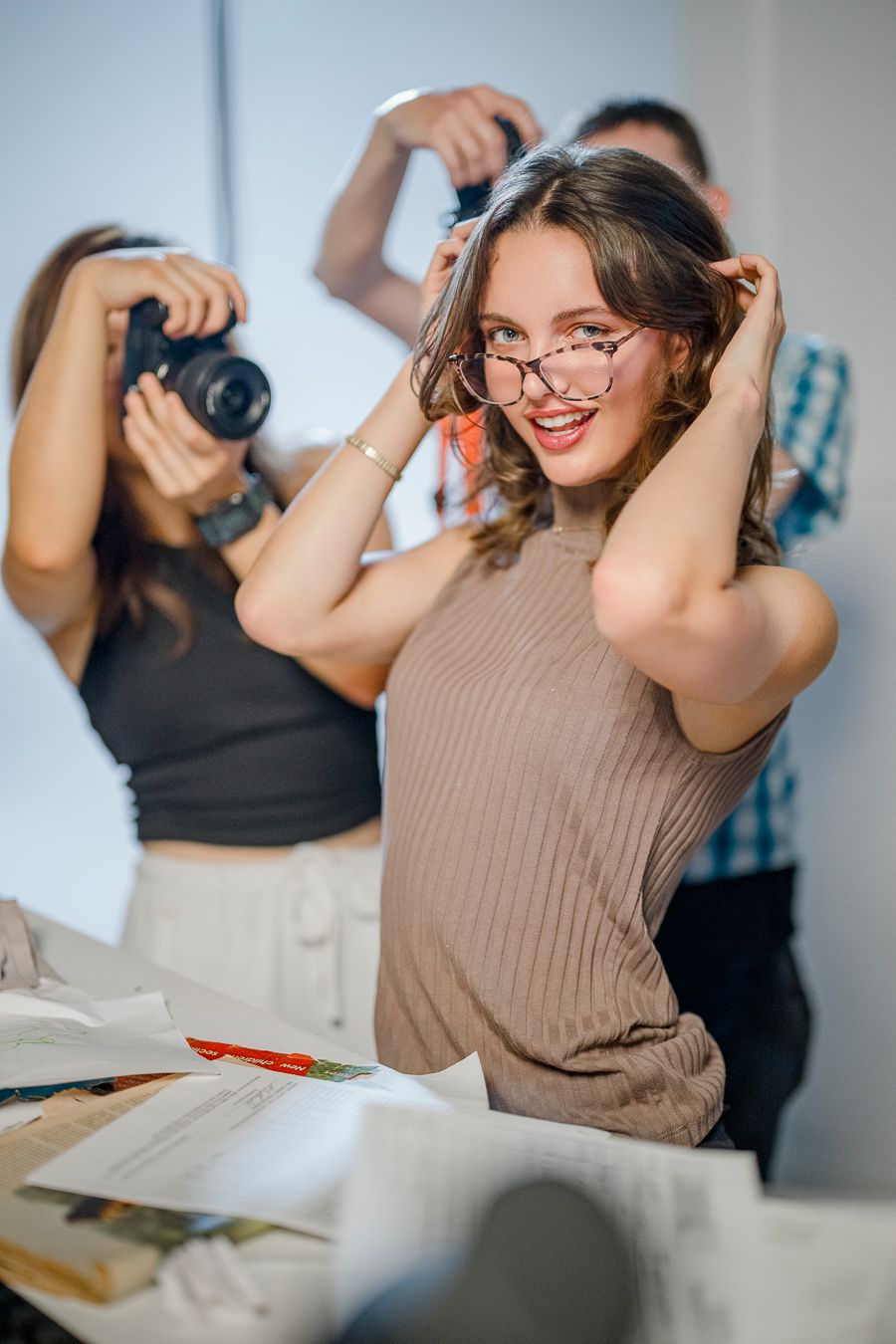 Candid shots of people laughing and taking photos during a creative session.