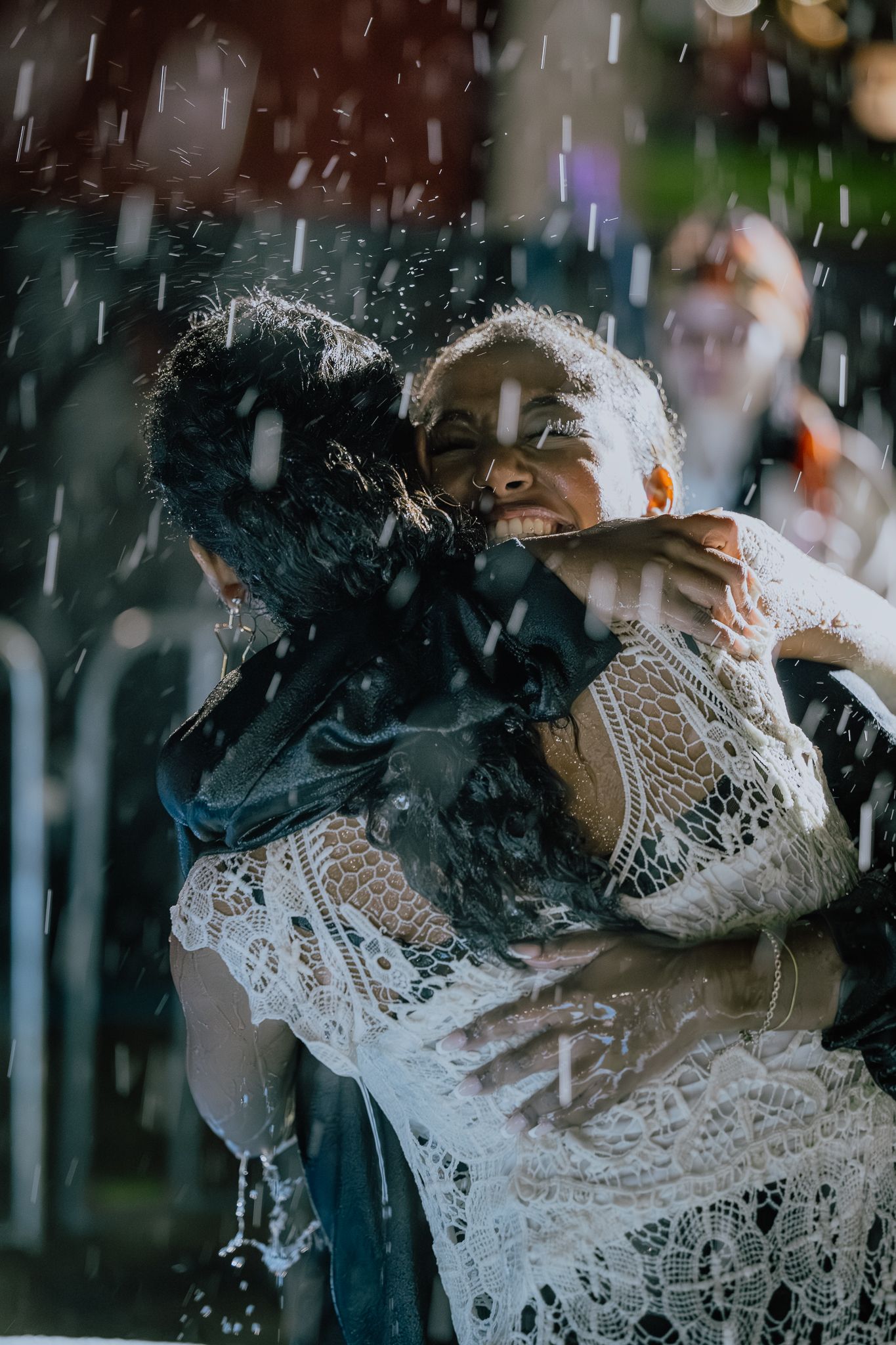 Close-up of baptism moment with water splashing in dramatic lighting.