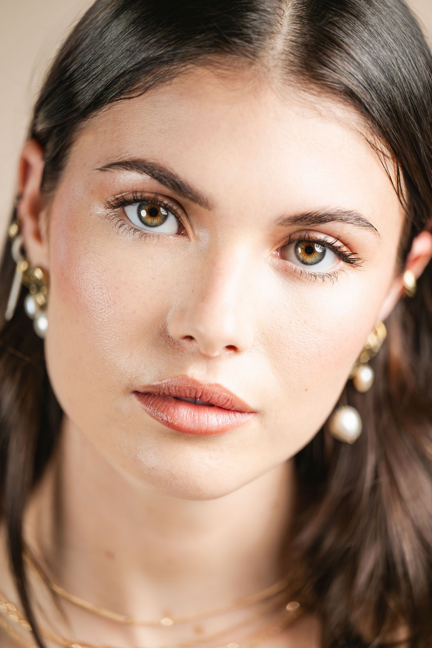 Beauty close-up portrait with pearl jewelry and natural makeup.