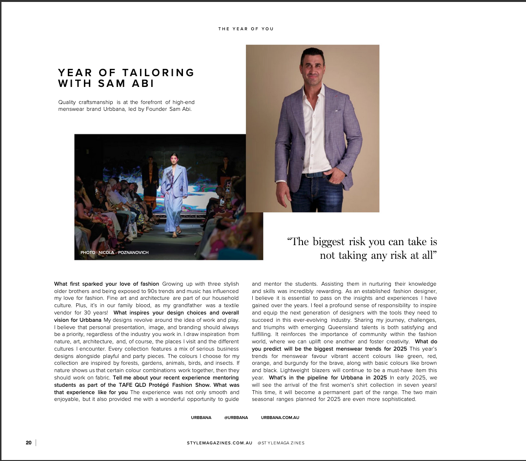 Fashion designer Sam Abi in a tailored suit seated confidently, featured in a Year of Tailoring magazine article.