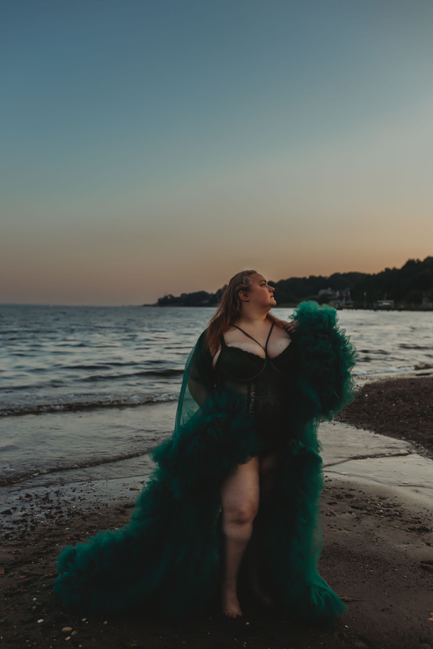 A series of artistic beach portraits at sunset showing ethereal movement with flowing green fabric against a moody coastline.