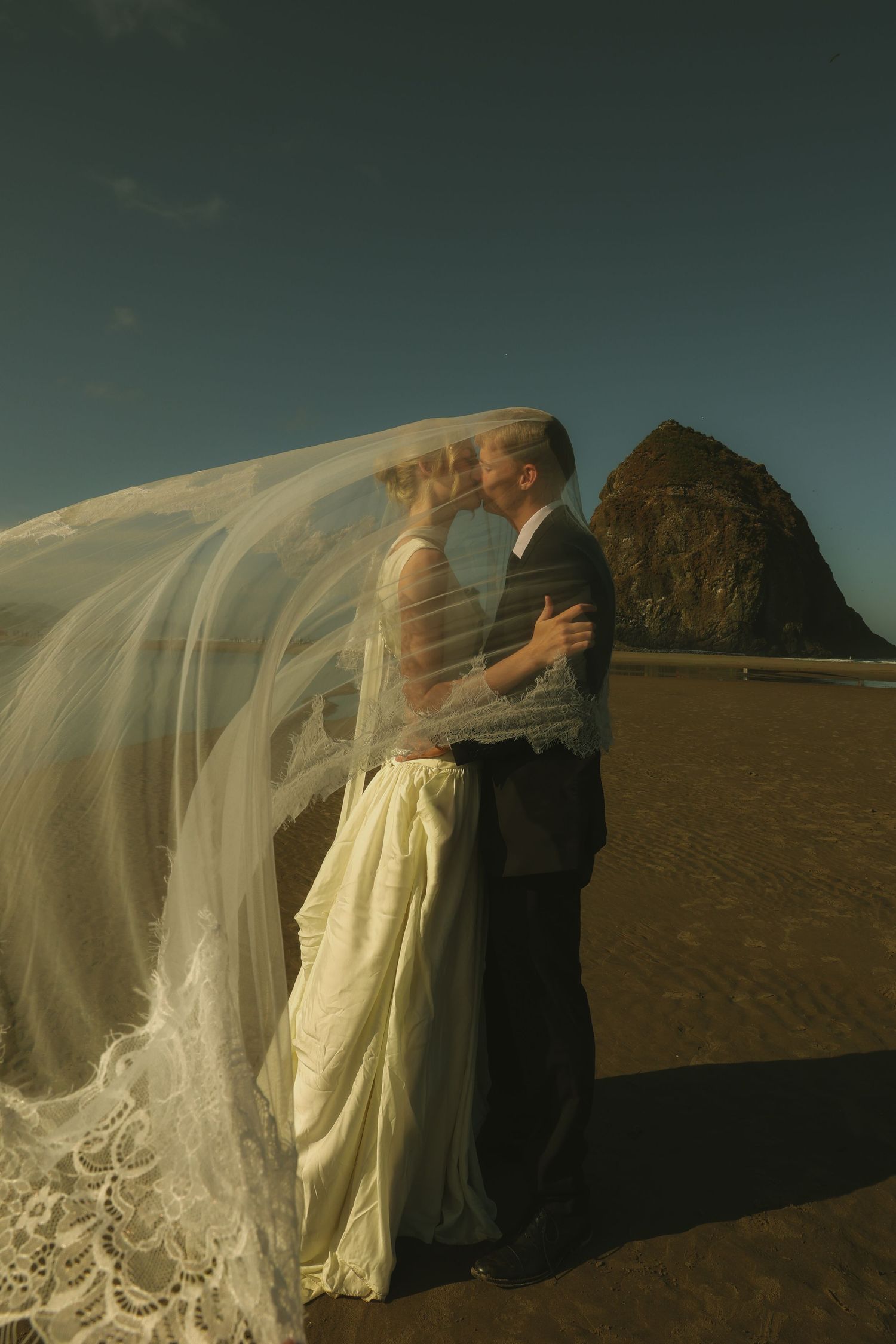 Cinematic Oregon Coast wedding photography capturing an intimate coastal elopement on the beach at Cannon Beach