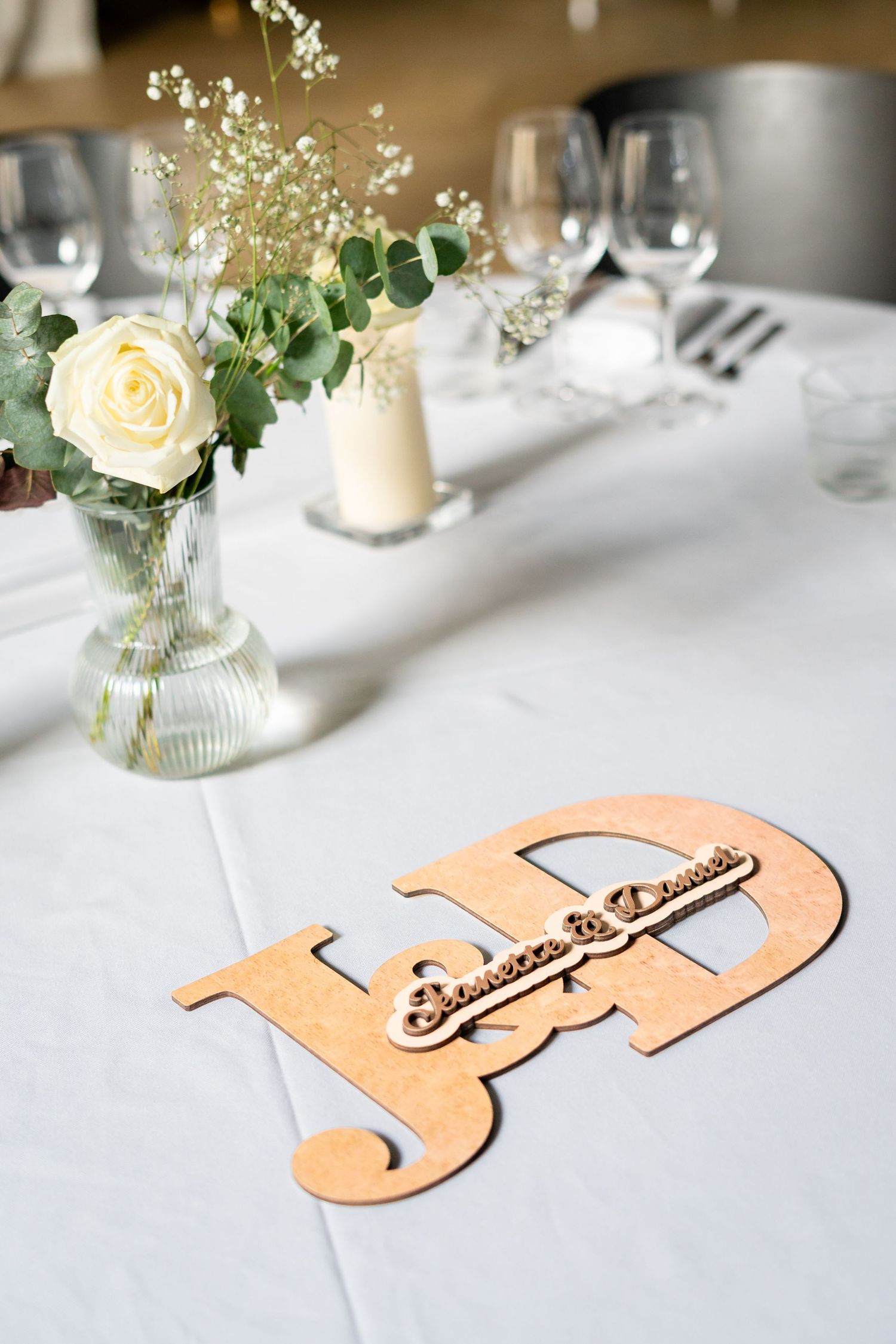 Wedding table setting with peach-colored decorative elements and fresh floral arrangements.