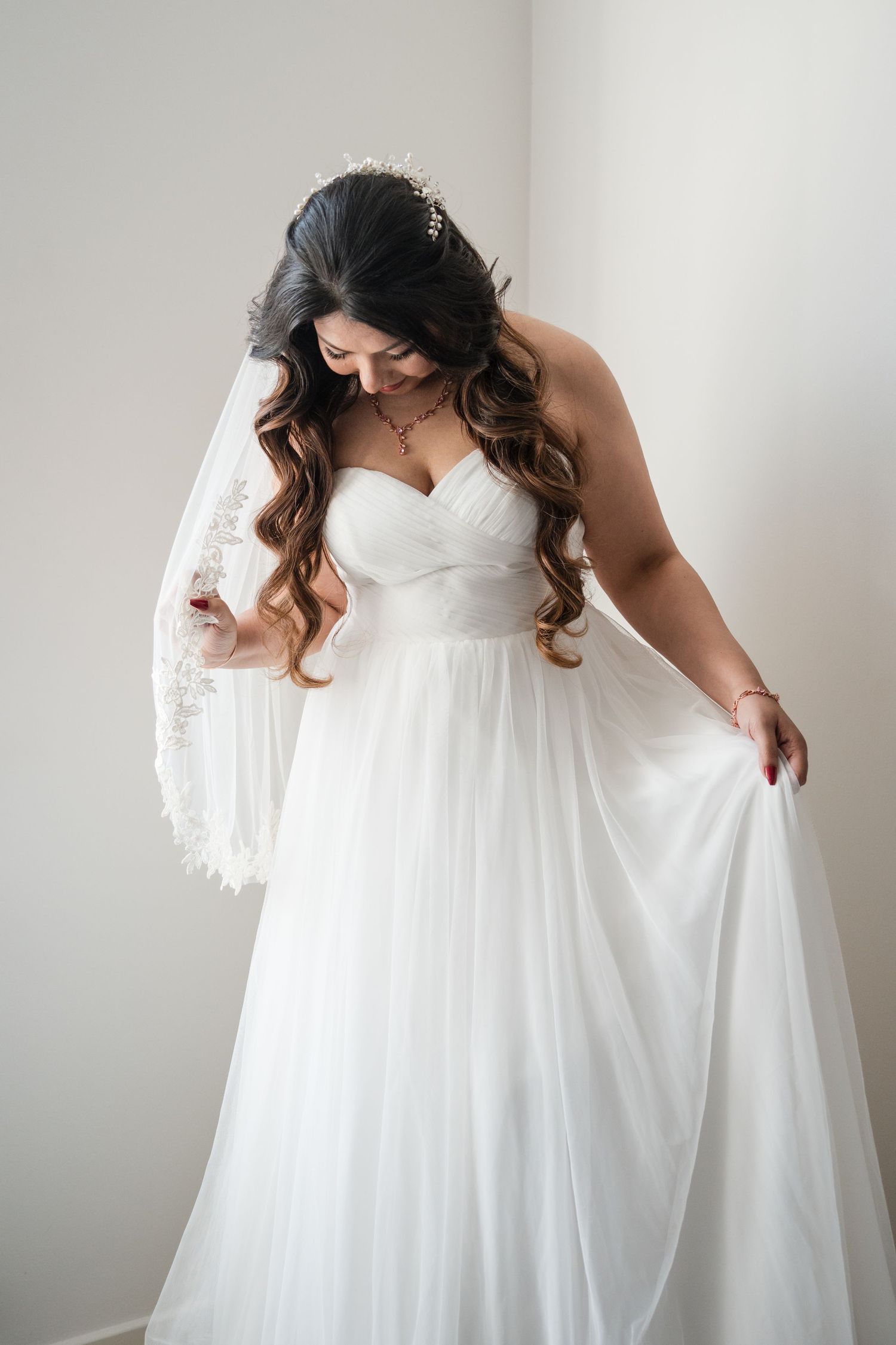 Ethereal bridal portrait showing the movement of a flowing white wedding gown.