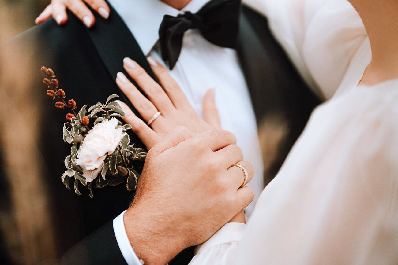 Close-up details of wedding attire and floral arrangements.