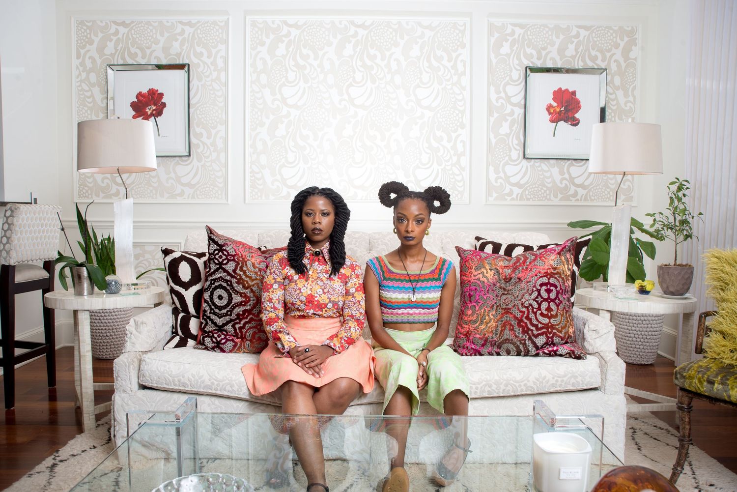 Modern portrait of people in interior design featuring a bright living room with white walls and natural light.