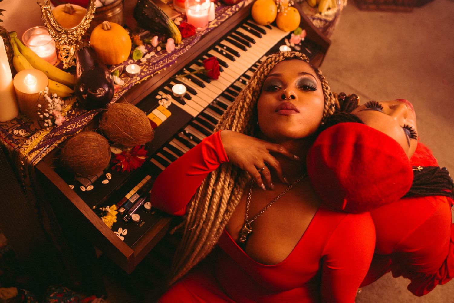 Musician portraits with electronic equipment in warm orange lighting.
