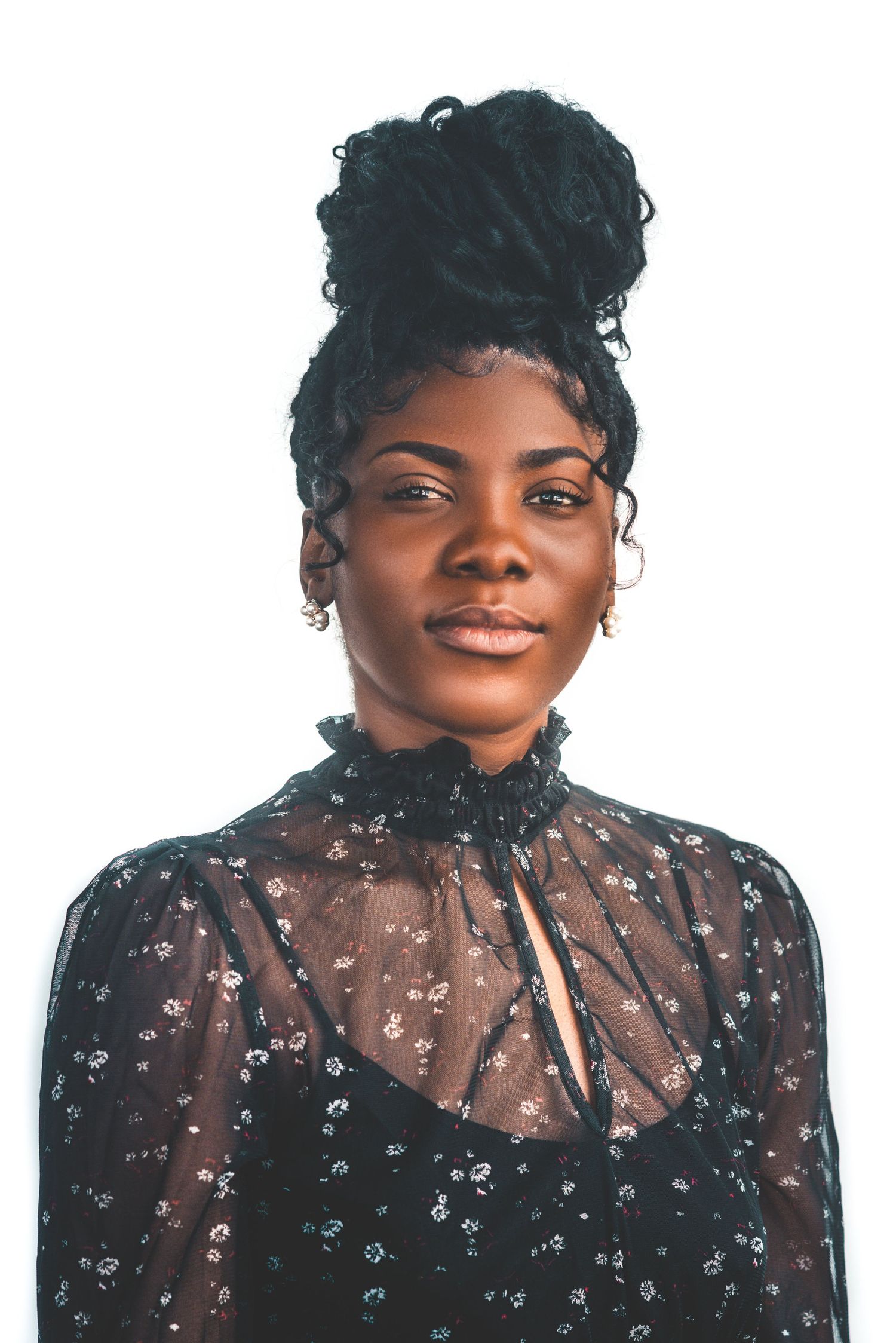 Portrait series showing woman in sheer floral dress with short curly hair against light background.