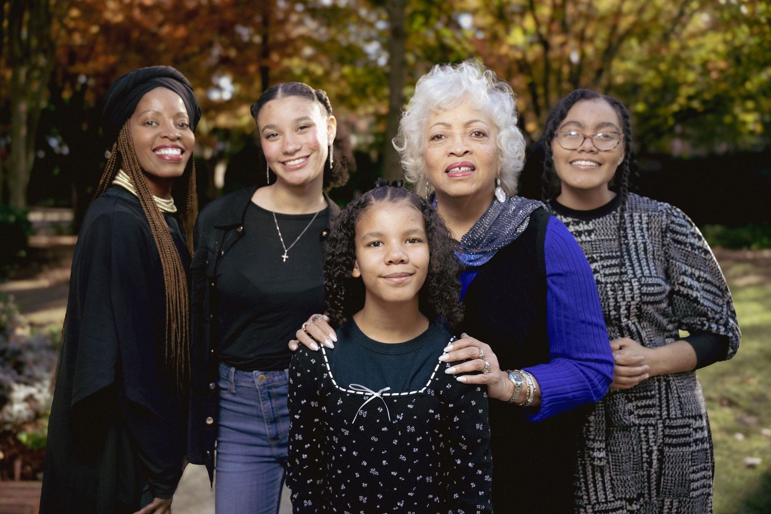 A series of candid outdoor family portraits showing joyful interactions and warm embraces in a natural setting.