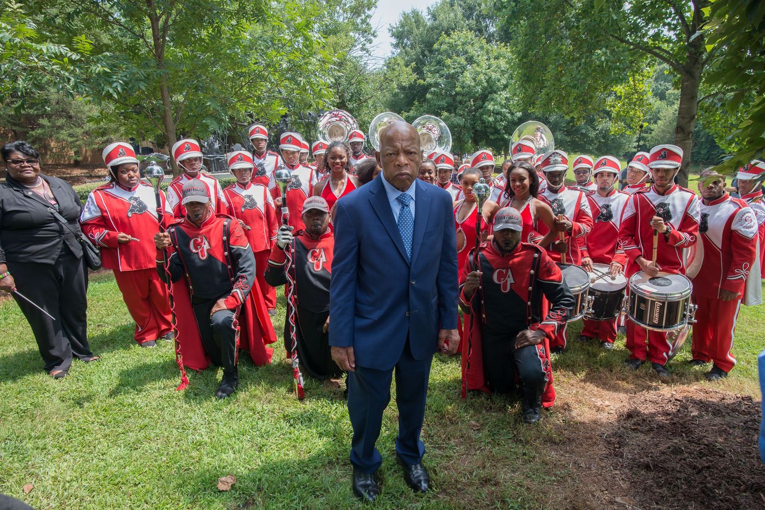 Large group in red uniforms gathered outdoors for a formal event or ceremony.