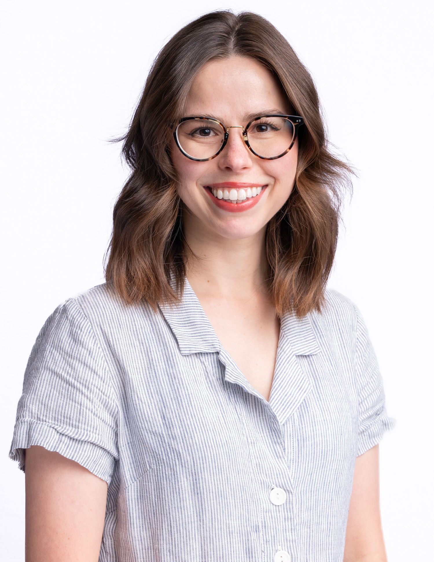 Professional headshot series showing same person in glasses and striped top with varying poses and expressions.