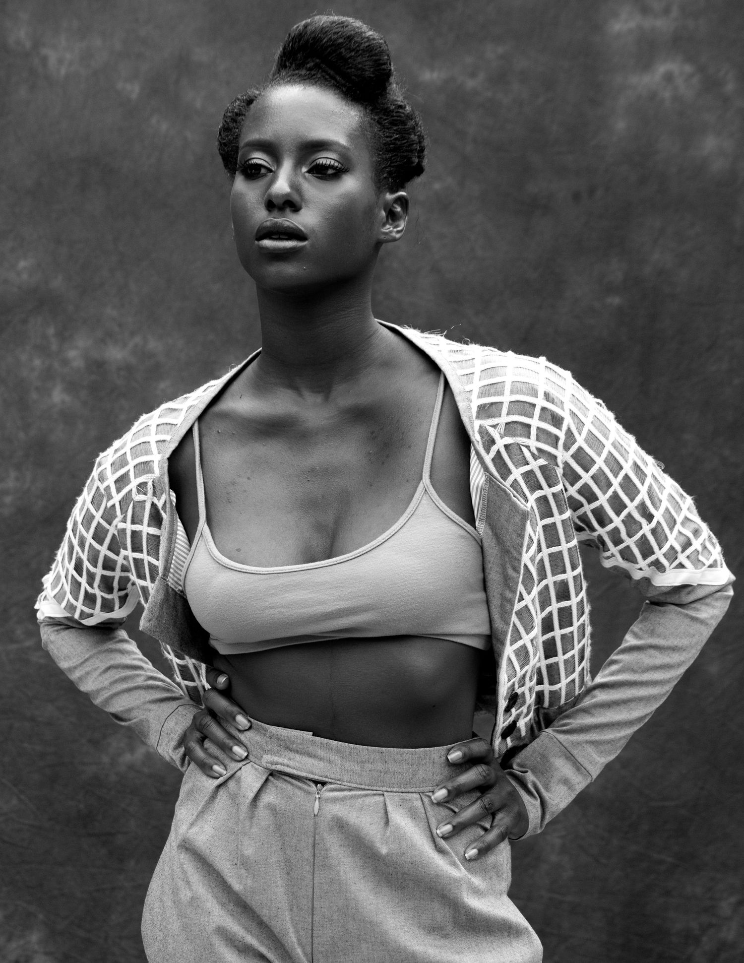 Black and white artistic portrait series showing expressive dance poses in a flowing white top against a dark background.