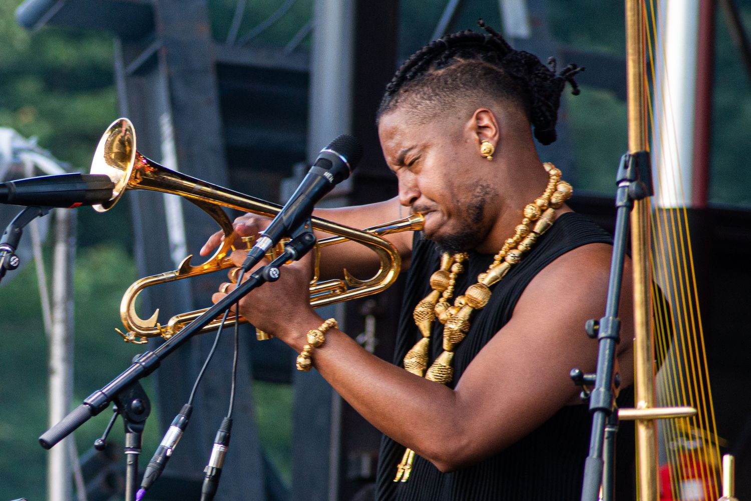 Musicians playing brass instruments on stage during a live performance.