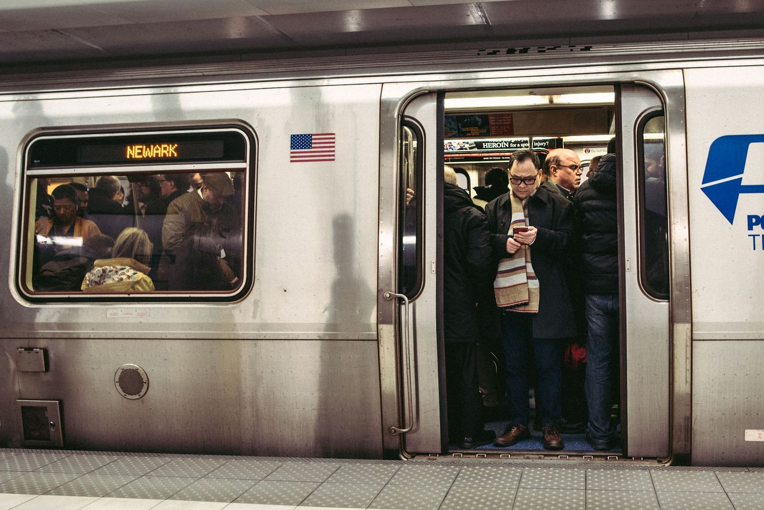 Interior view of a subway car showing passengers and windows during transit.