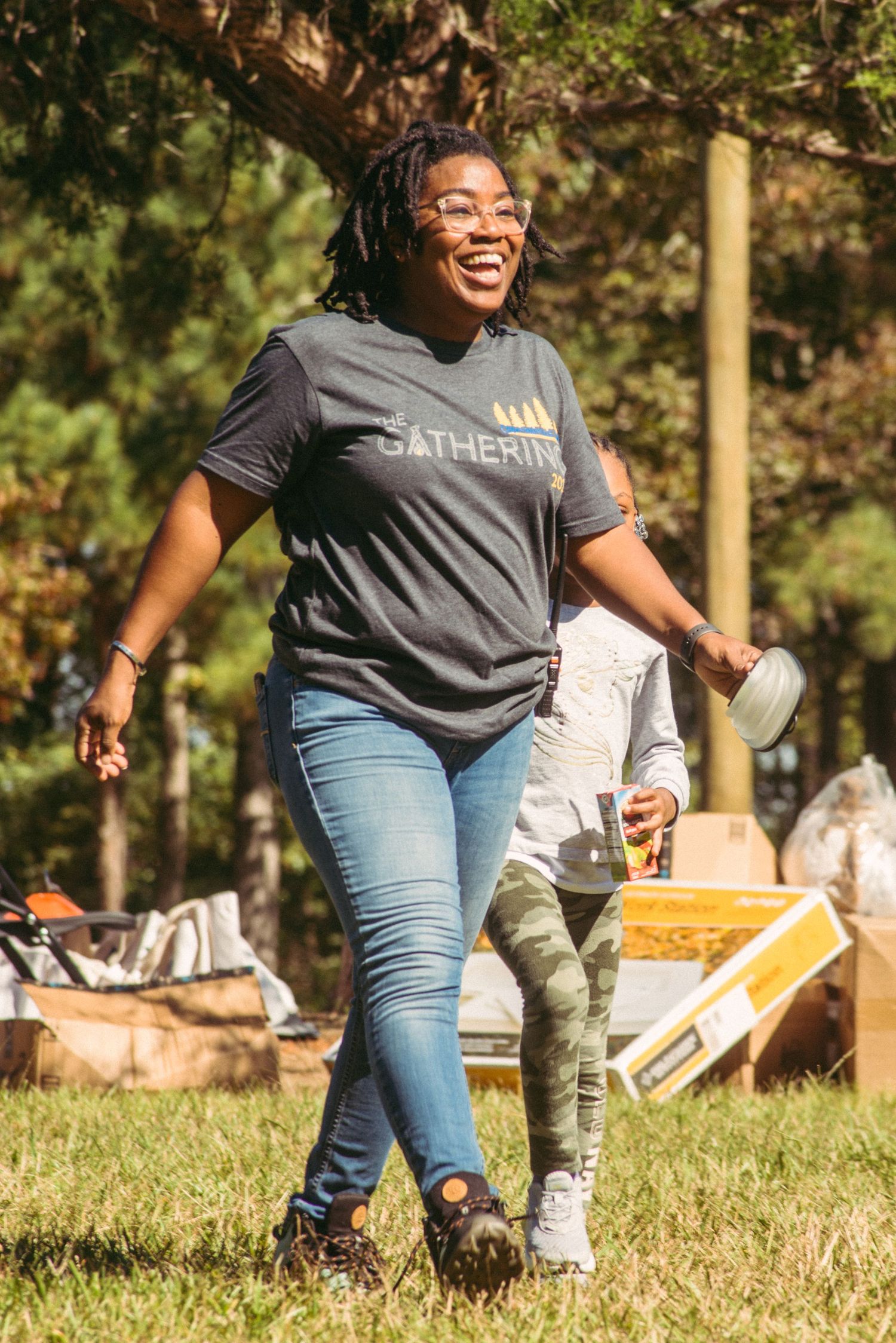 People enjoying an outdoor gathering in a sunny park with casual attire and relaxed atmosphere.