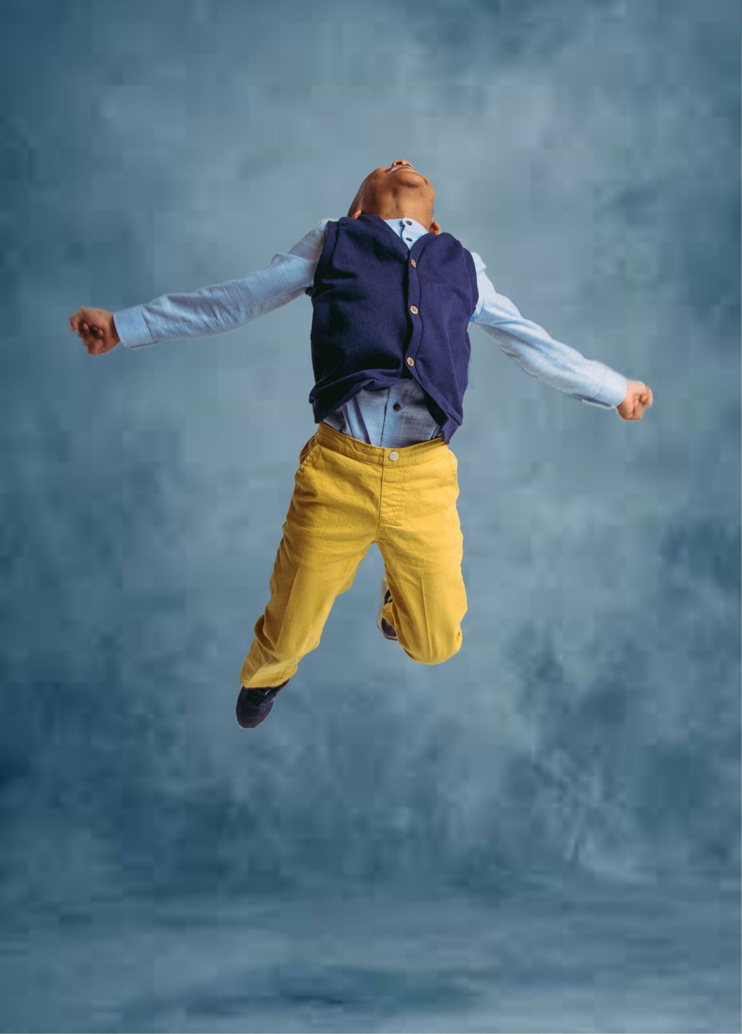 Dynamic sequence of a dancer in yellow pants and navy shirt performing a graceful aerial jump against a blue backdrop.