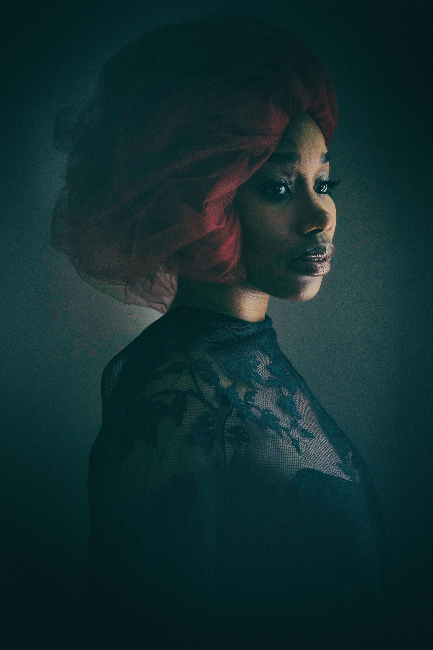 Moody profile portraits in dark teal lighting with dramatic shadows.