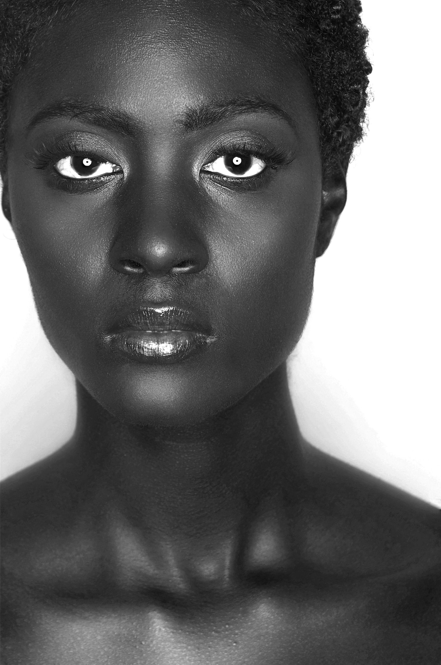Dramatic black and white portrait showcasing intense gaze and striking facial features.