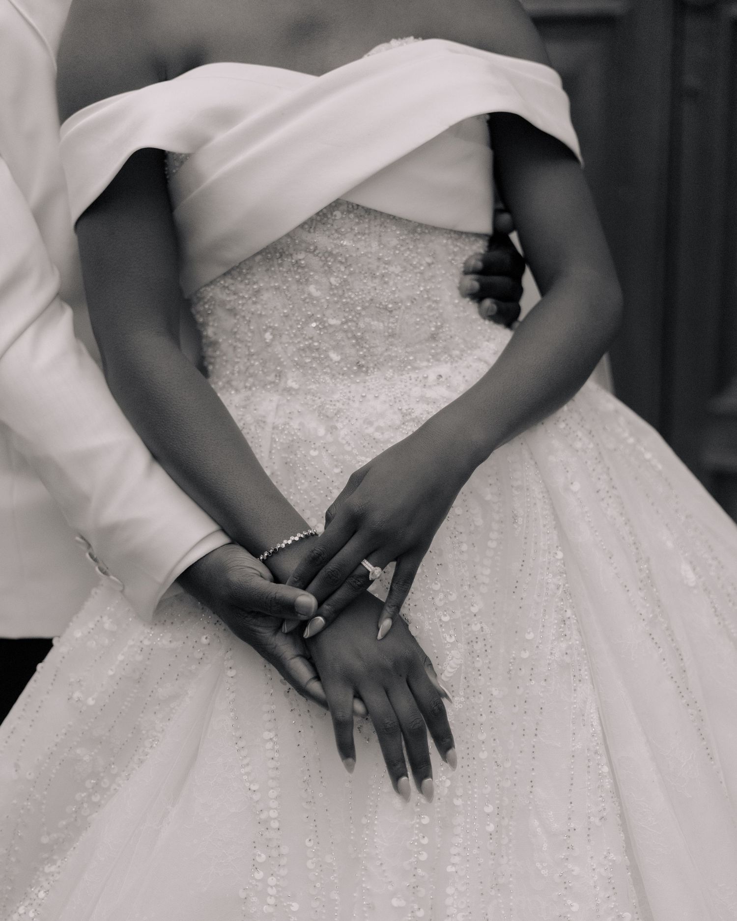 black and white image of couple holding hands