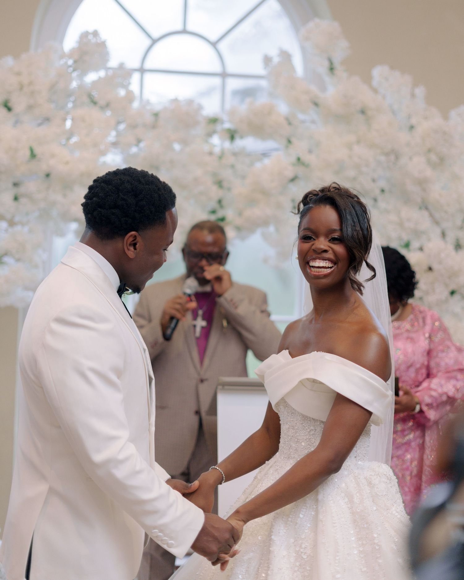 couple holding hands at the altar