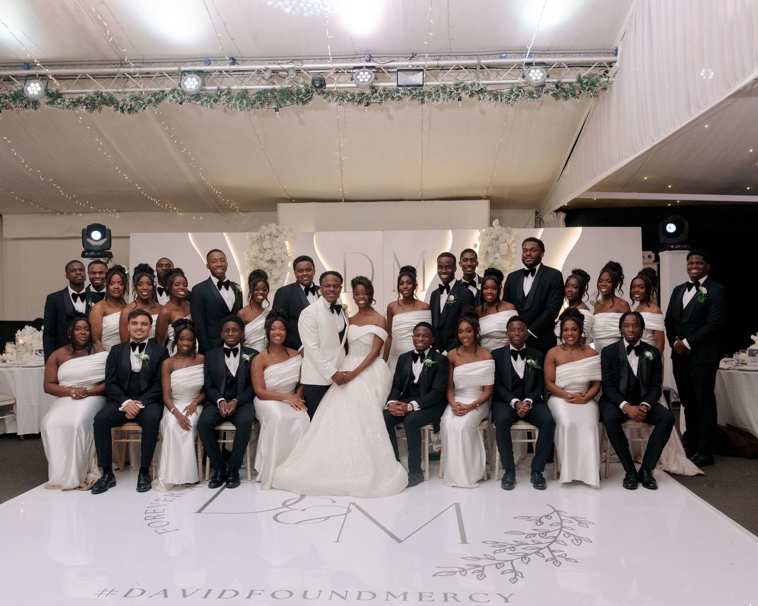 bridal team and couple at reception dance floor group picture
