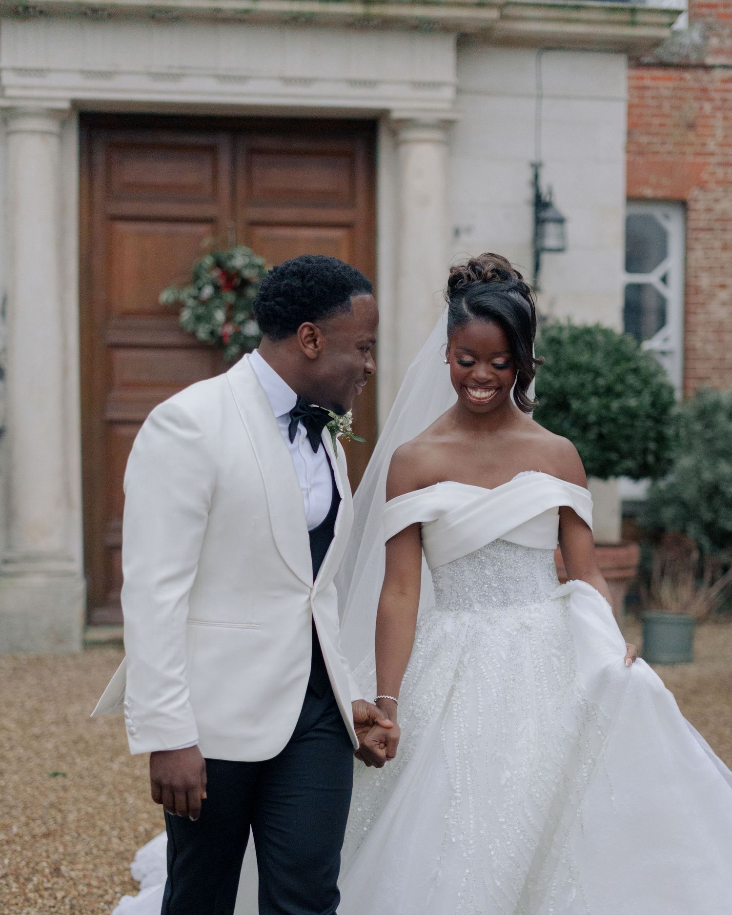 bride and groom holding hands