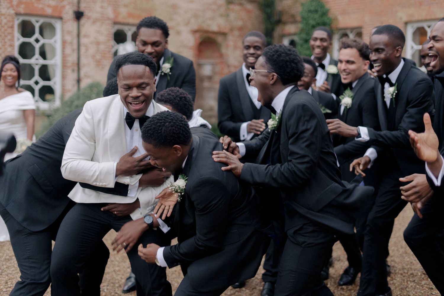 groom picked up by his boys to celebrate him on his wedding day