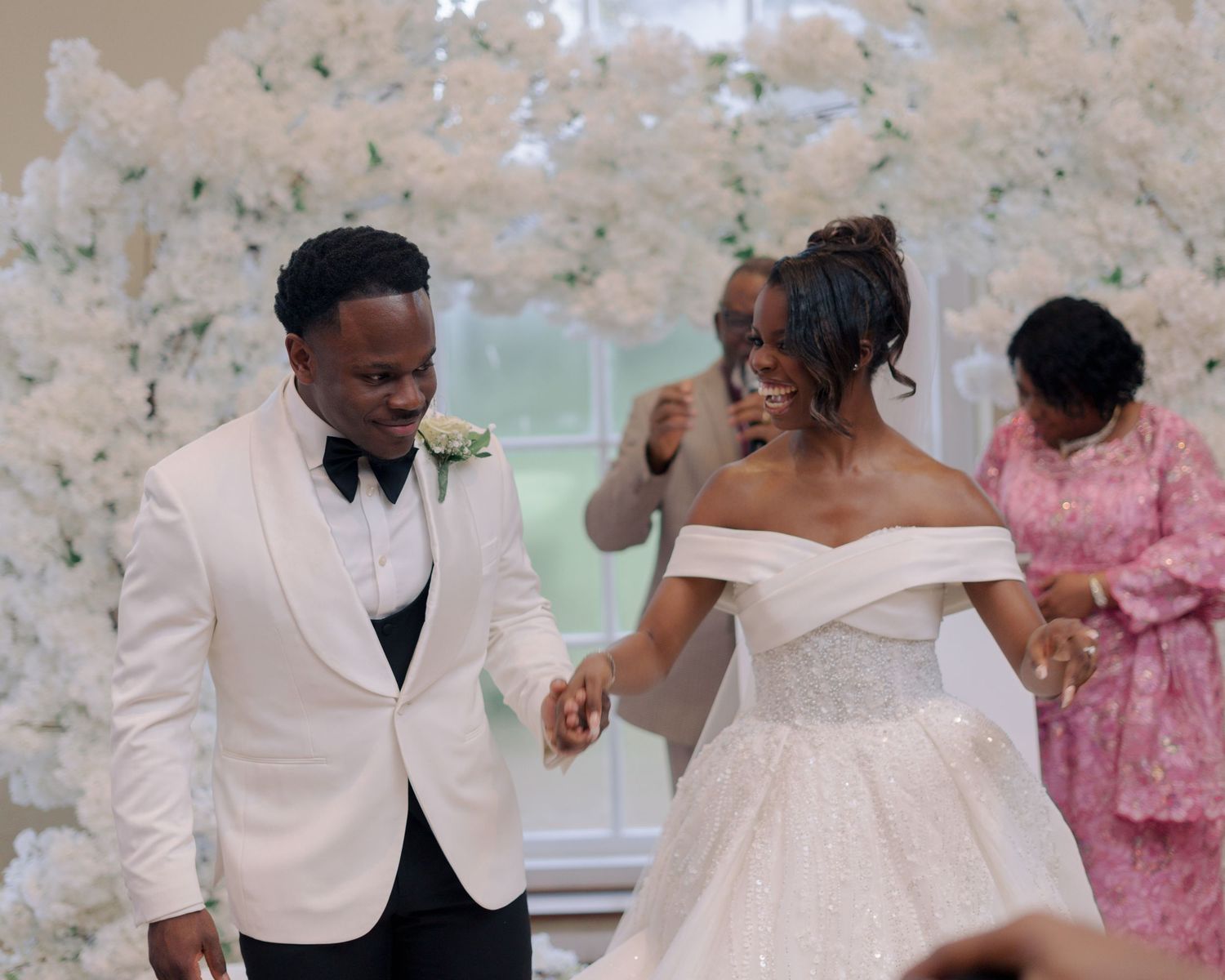 couple dancing down aisle after being announced husband and wife.