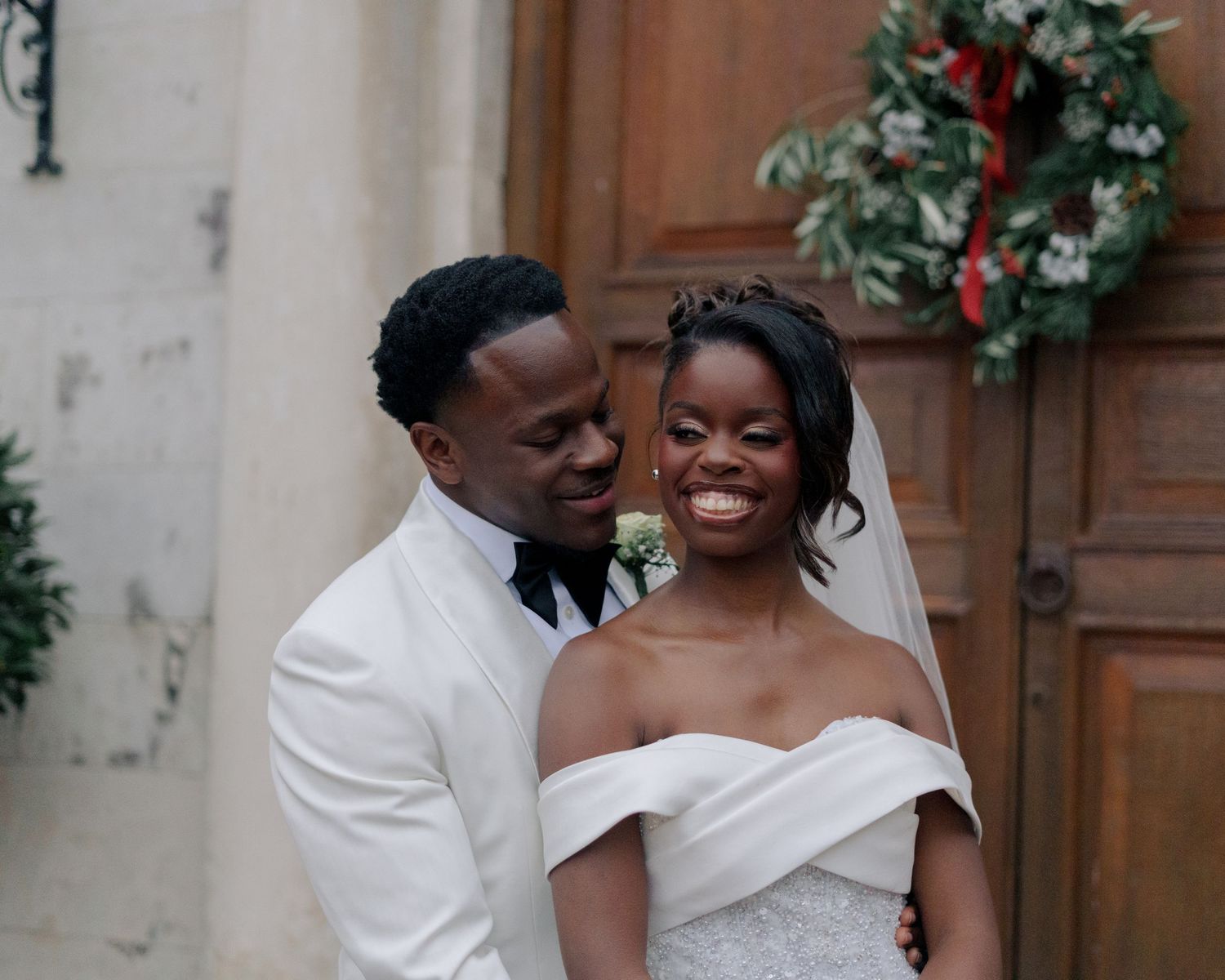 couple posing in front of door at braxted park estate