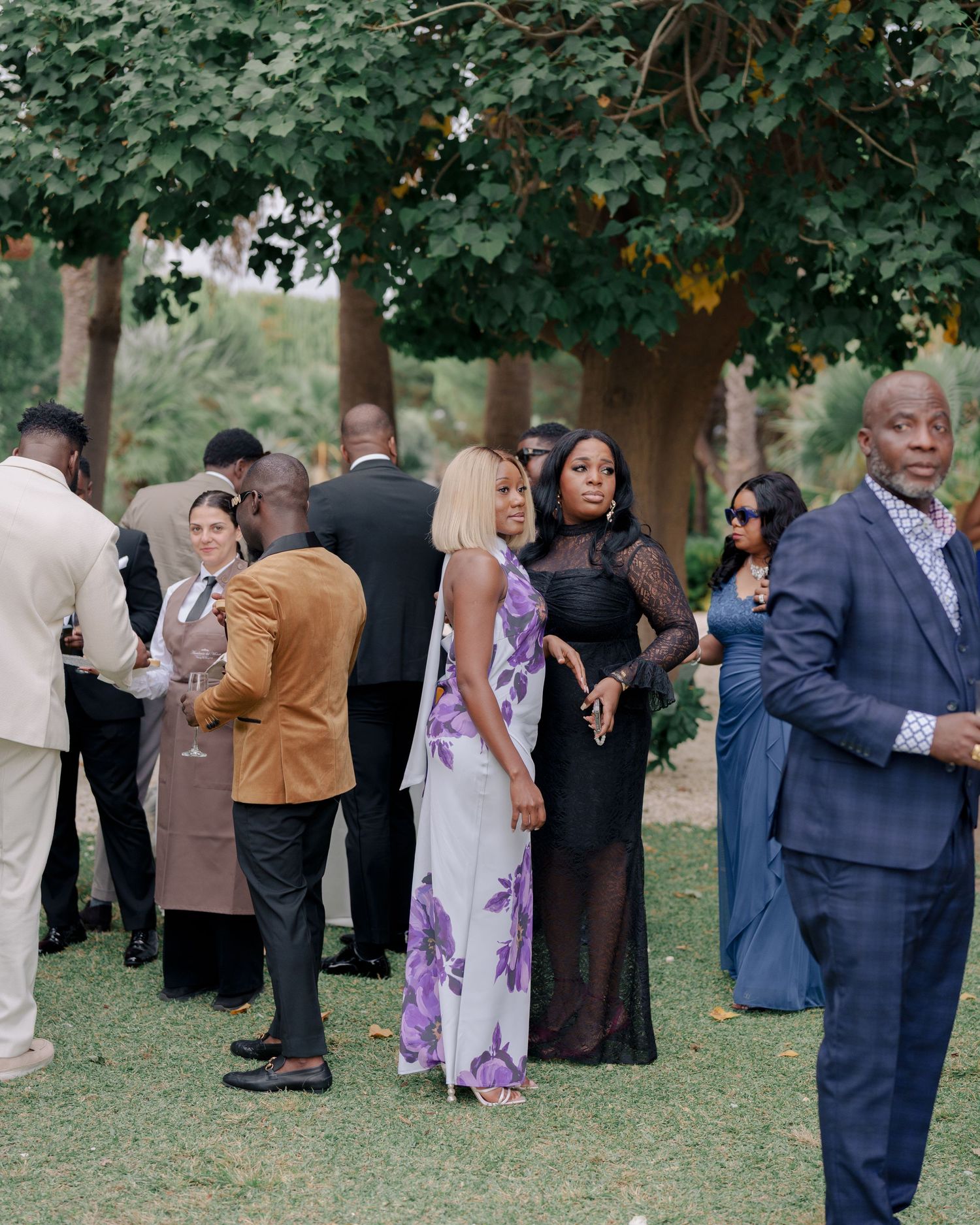 Candid shot of guests enjoying canapés after an outdoor destination ceremony in Sicily, Italy.